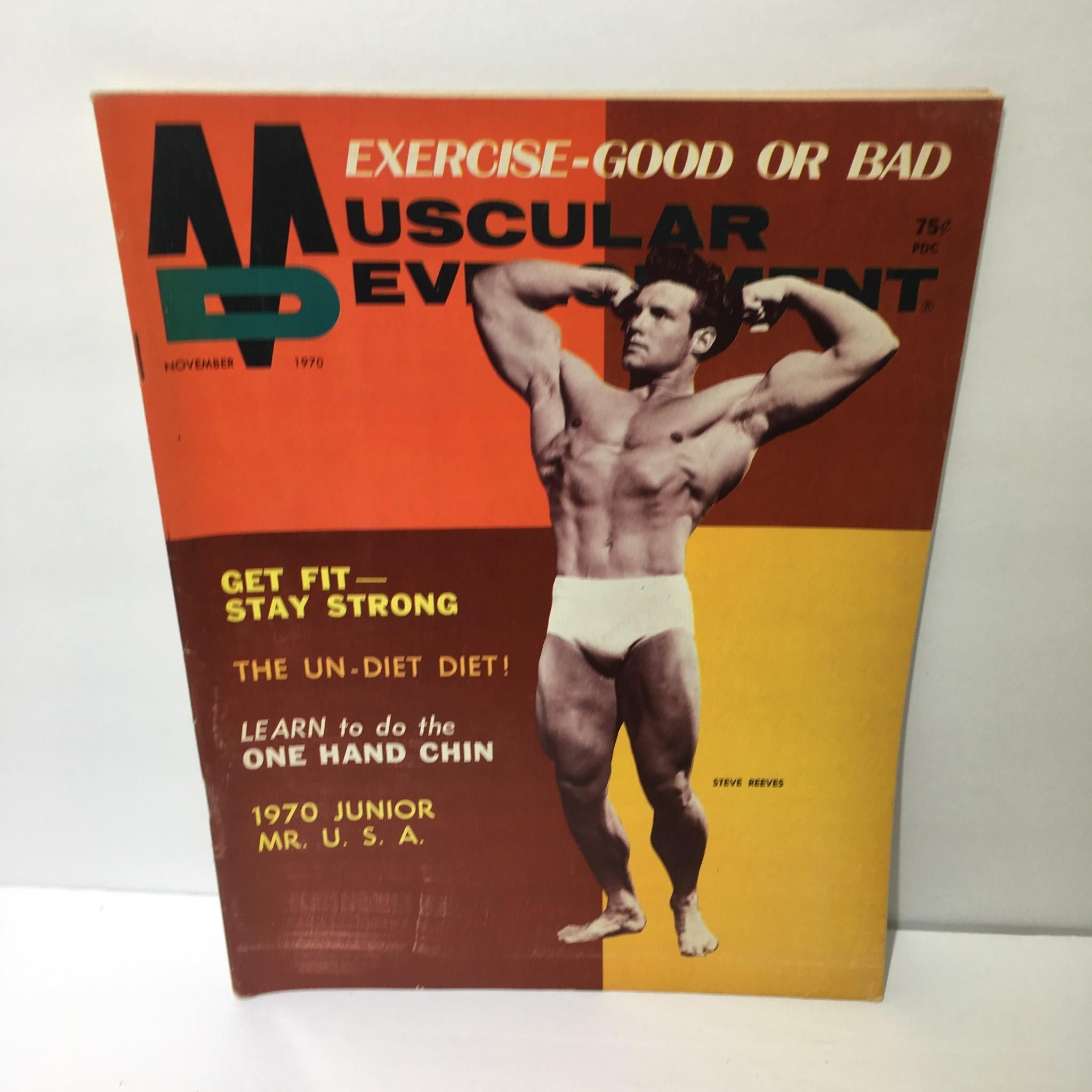 Cover of Muscular Development Magazine featuring Steve Reeves, November 1970. The cover showcases Steve Reeves flexing his muscles with titles including 'Get Fit - Stay Strong' and 'Exercise - Good or Bad'. This vintage magazine is a collectible piece of bodybuilding history.