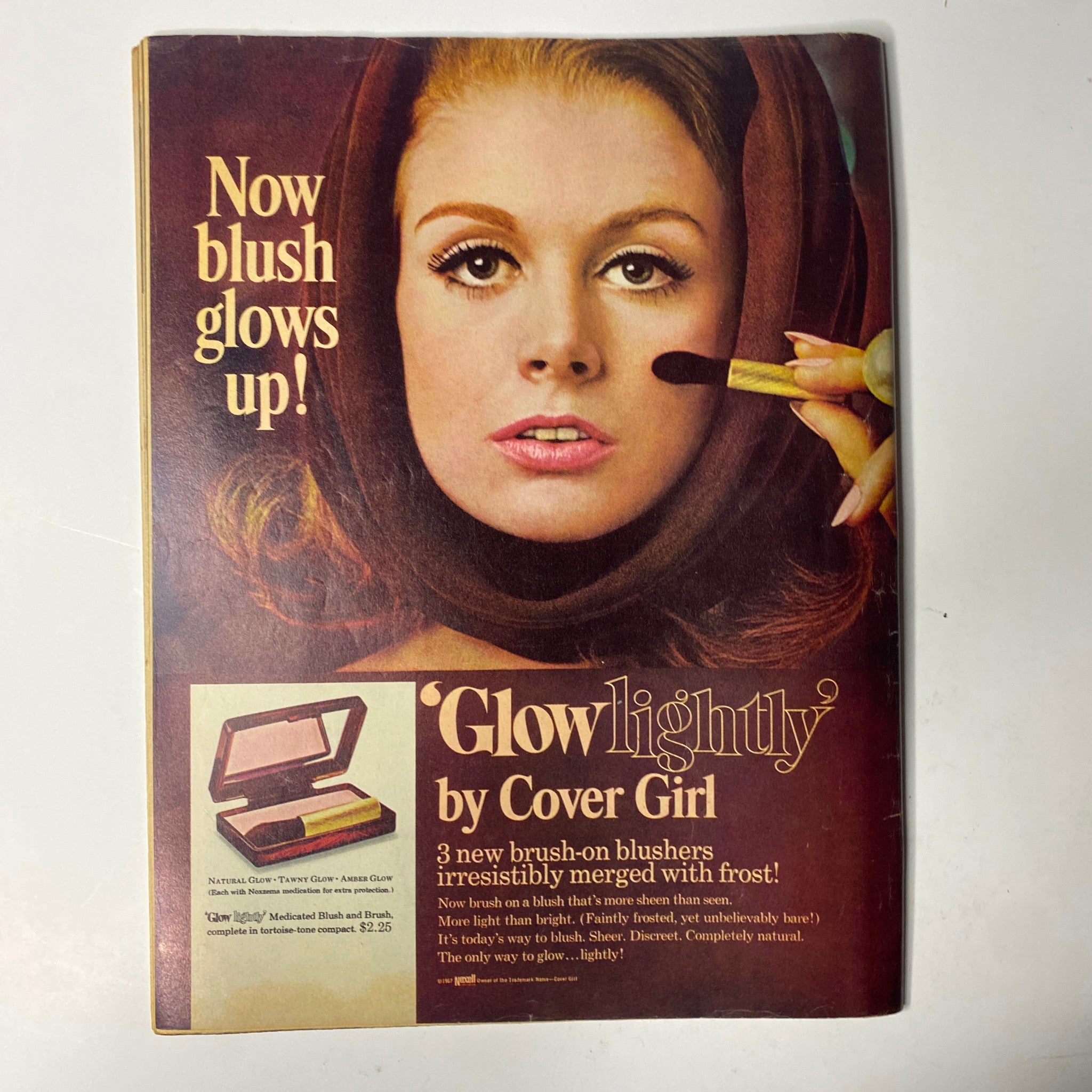 TeenSet Magazine August 1967 advertisement for Cover Girl's 'Glowlightly' blush, featuring a model applying makeup with the tagline 'Now blush glows up!'