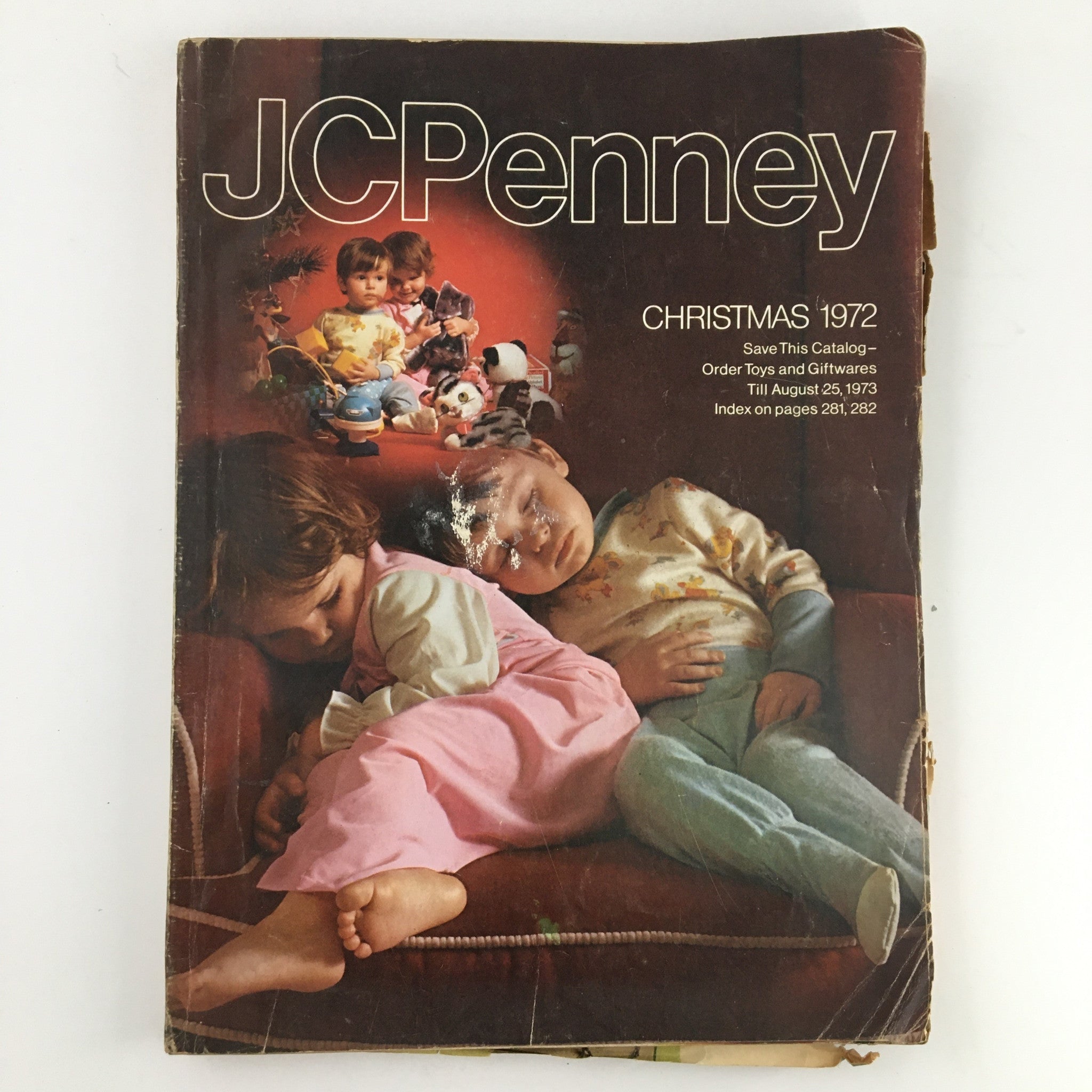 Cover image of the 1972 JCPenney Christmas Toys and Giftwares Price Guide Catalog featuring children sleeping amongst toys, showcasing the nostalgic charm of holiday memories.