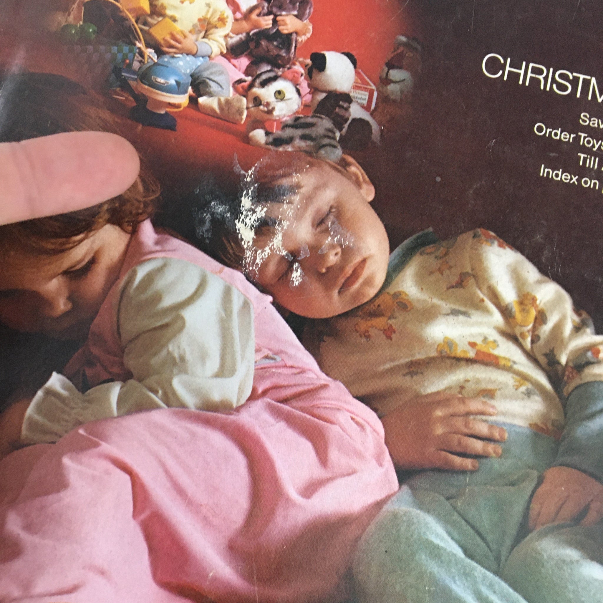 Close-up of the cover page of the 1972 JCPenney Christmas Toys and Giftwares Price Guide Catalog, highlighting the faded yet charming imagery of children and toys.