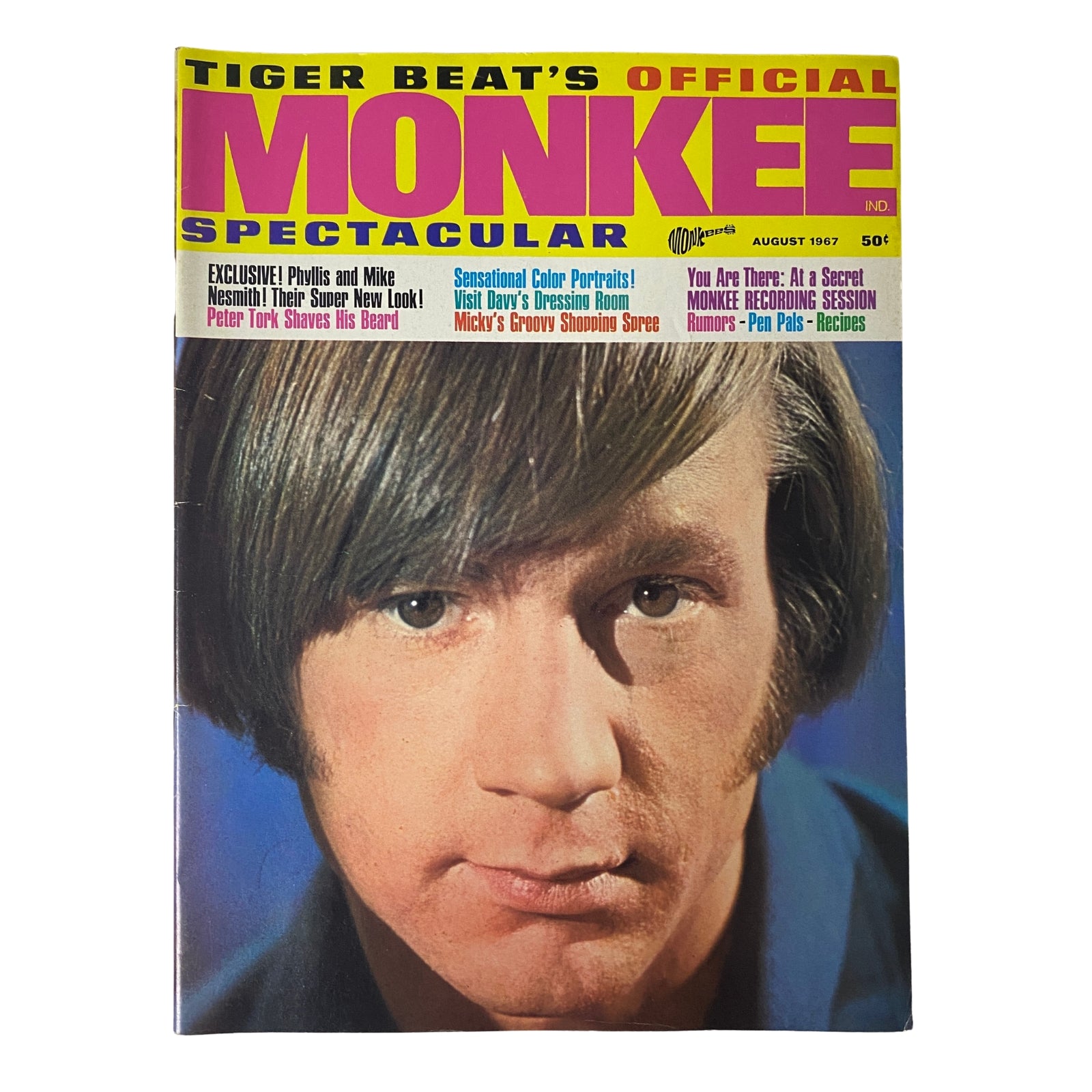 Cover of Tiger Beat's Official August 1967 #4 Monkee Spectacular featuring a vibrant photograph of Micky Dolenz with a focus on his hairstyle and clothing.