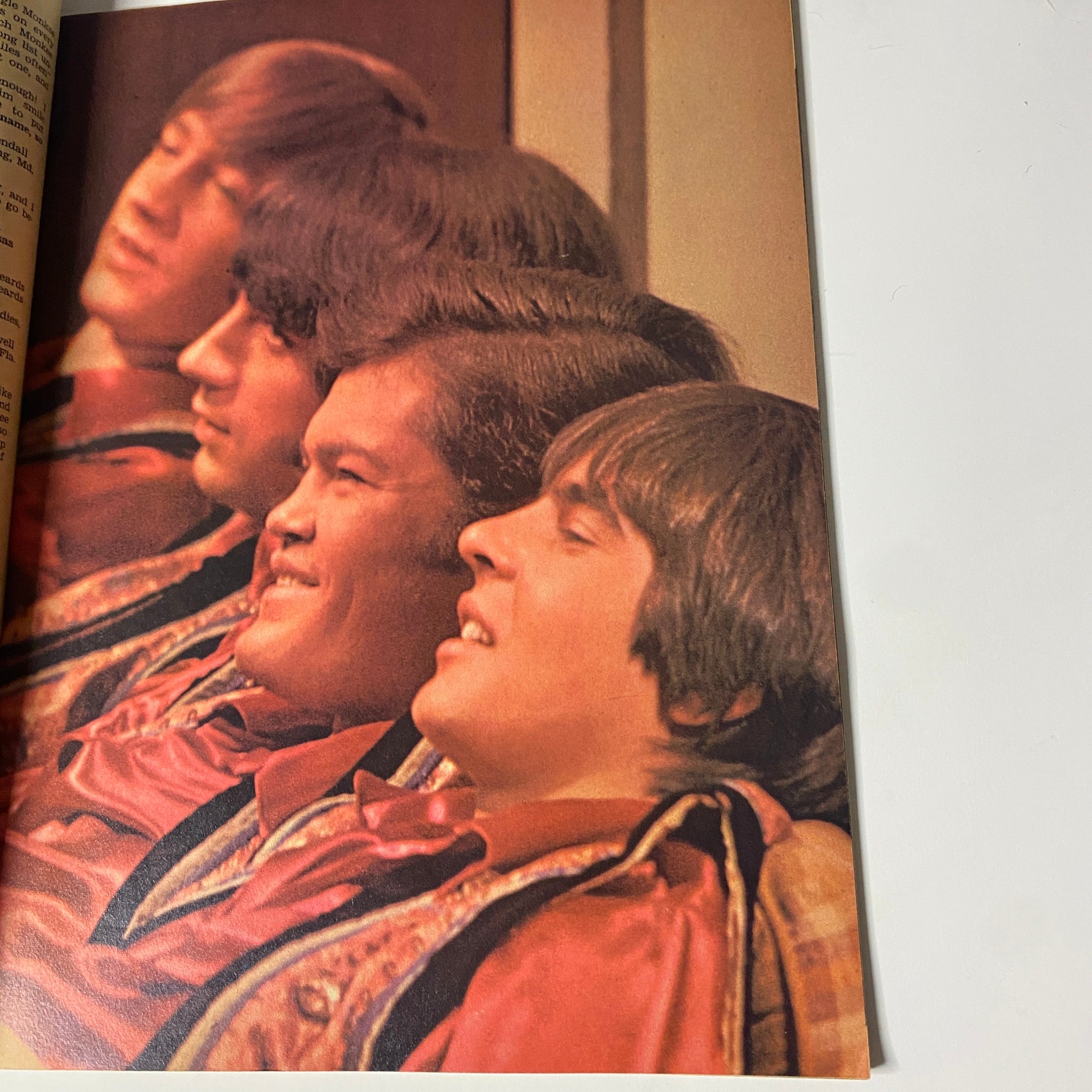 A page from Tiger Beat's Official August 1967 #4 Monkee Spectacular displaying a group photo of the Monkees in colorful outfits, highlighting their iconic 1960s style.
