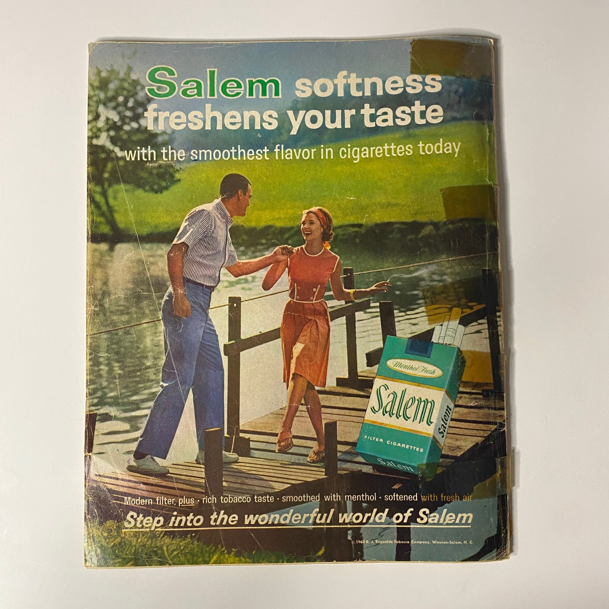 Back cover of Photoplay Magazine August 1964 with an advertisement for Salem cigarettes, featuring a couple on a dock by the water. The ad promotes 'Salem softness' and highlights the brand's smooth flavor, fitting into the vintage aesthetics of the era.