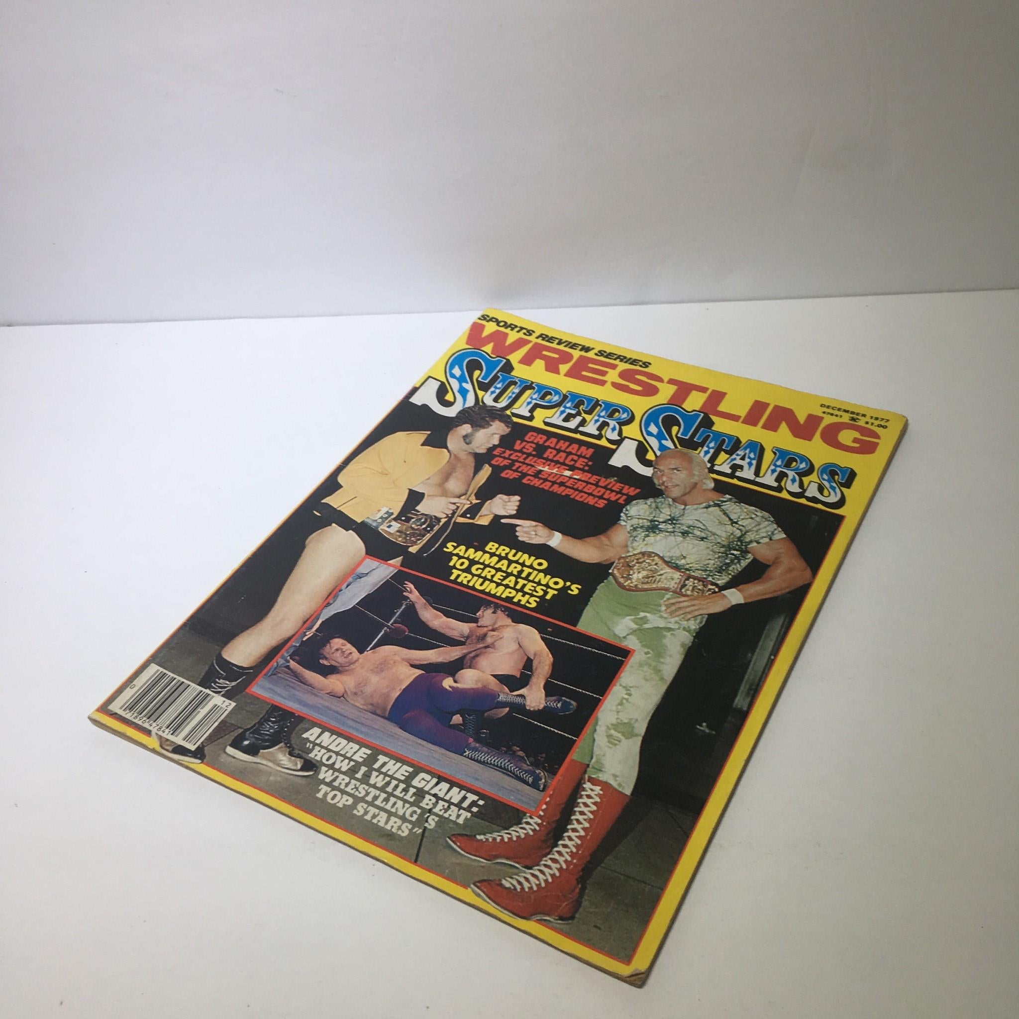Cover of the Sports Review Series: Wrestling Super Stars December 1977 magazine, displaying a thrilling wrestling match between notable stars including Graham and Race, capturing the excitement of the era.