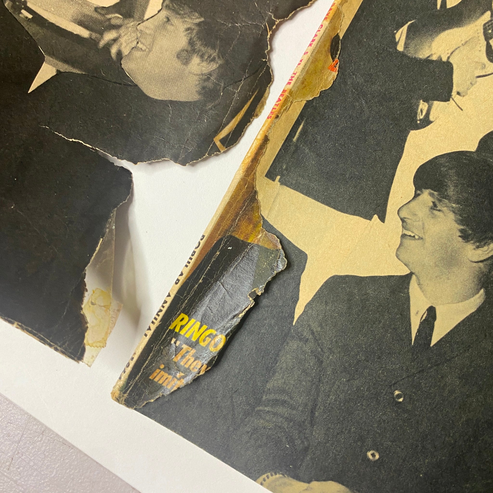 Close-up of the damaged cover of 'Popular Annual Magazine 1964' featuring Ringo Starr from The Beatles, illustrating the wear and tear of this vintage publication.