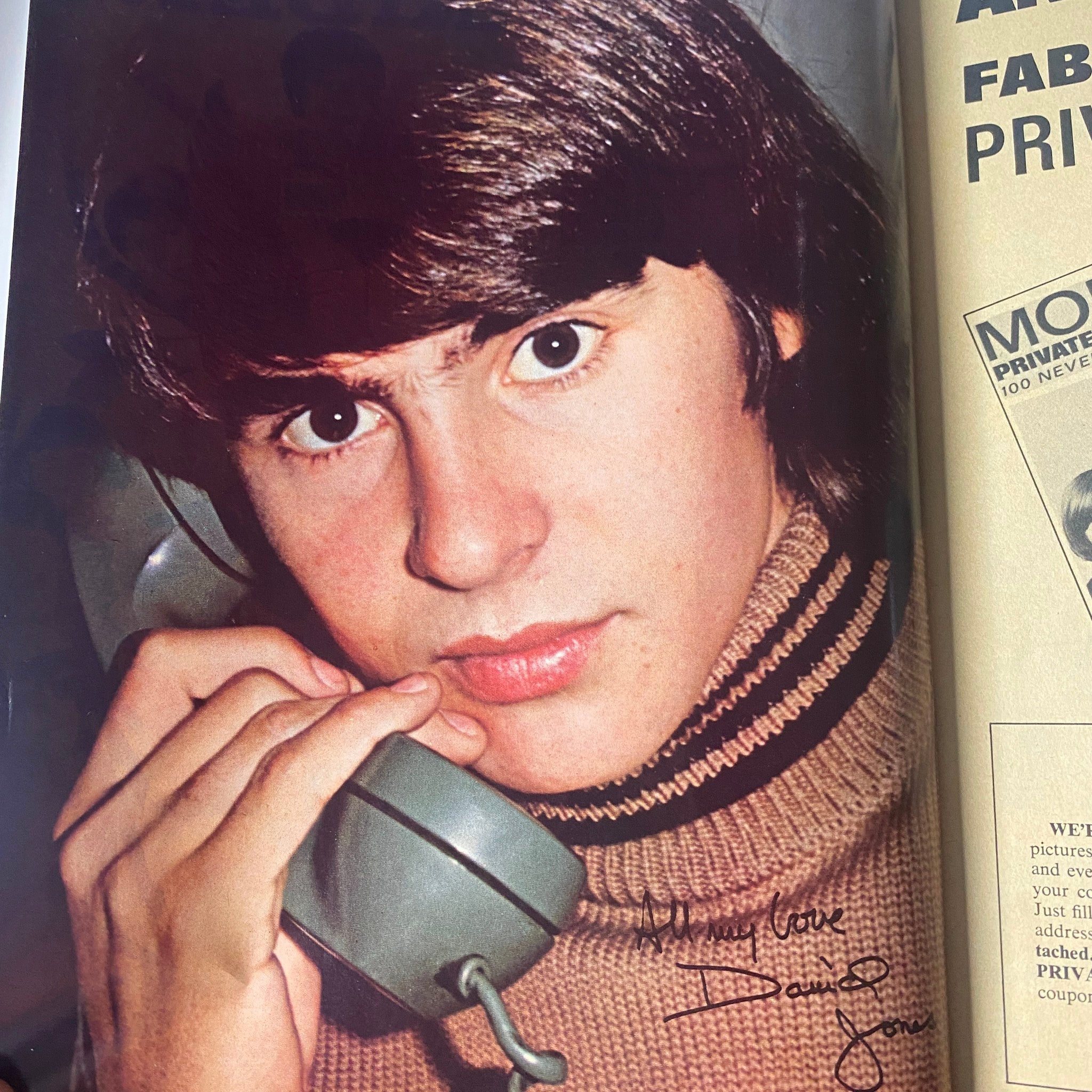 Close-up image of Davy Jones from 16 Magazine June 1967 Vol 9 No. 1 where he is holding a telephone, showcasing his classic hairstyle.