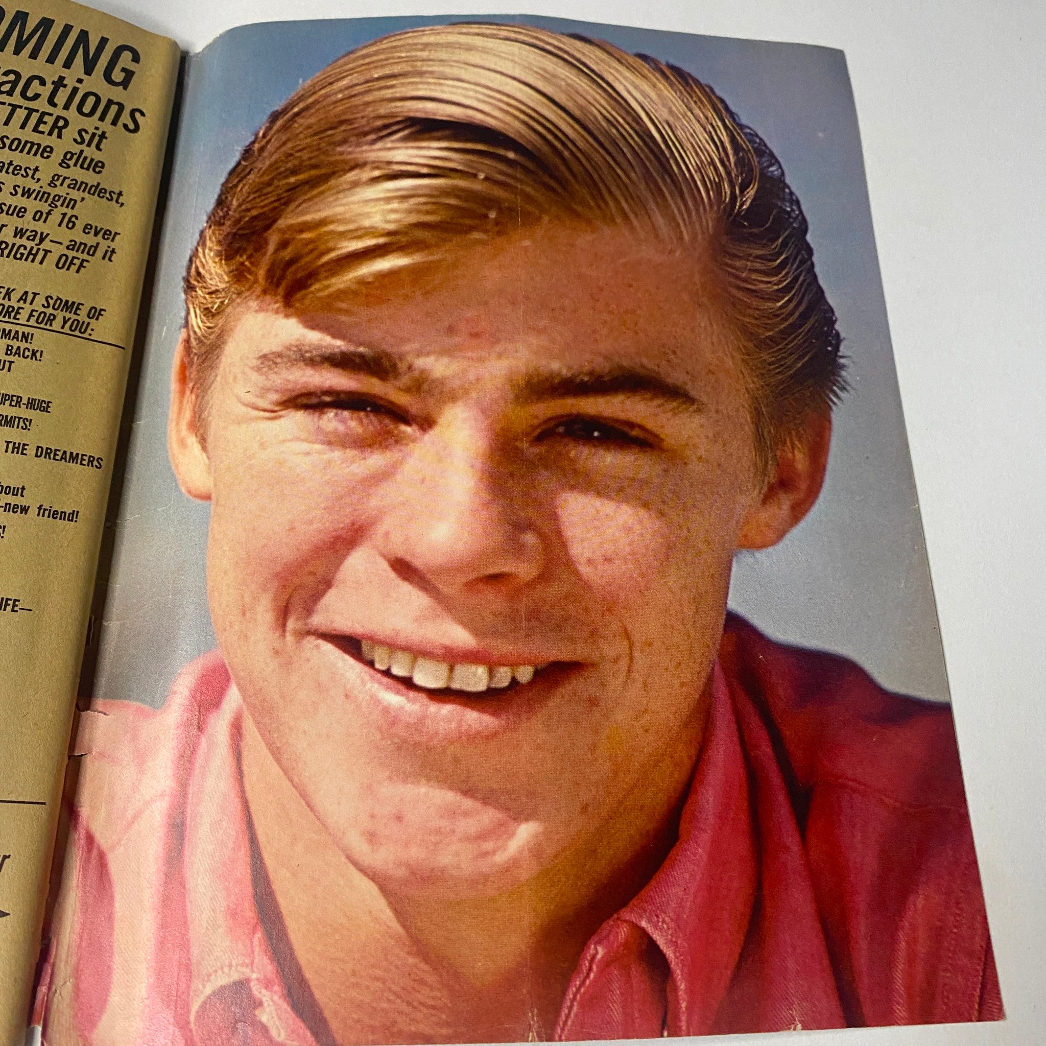 Image of a smiling young male star captured in 16 Magazine August 1965 Vol 7 No. 3, displaying a charming expression and stylish hair.