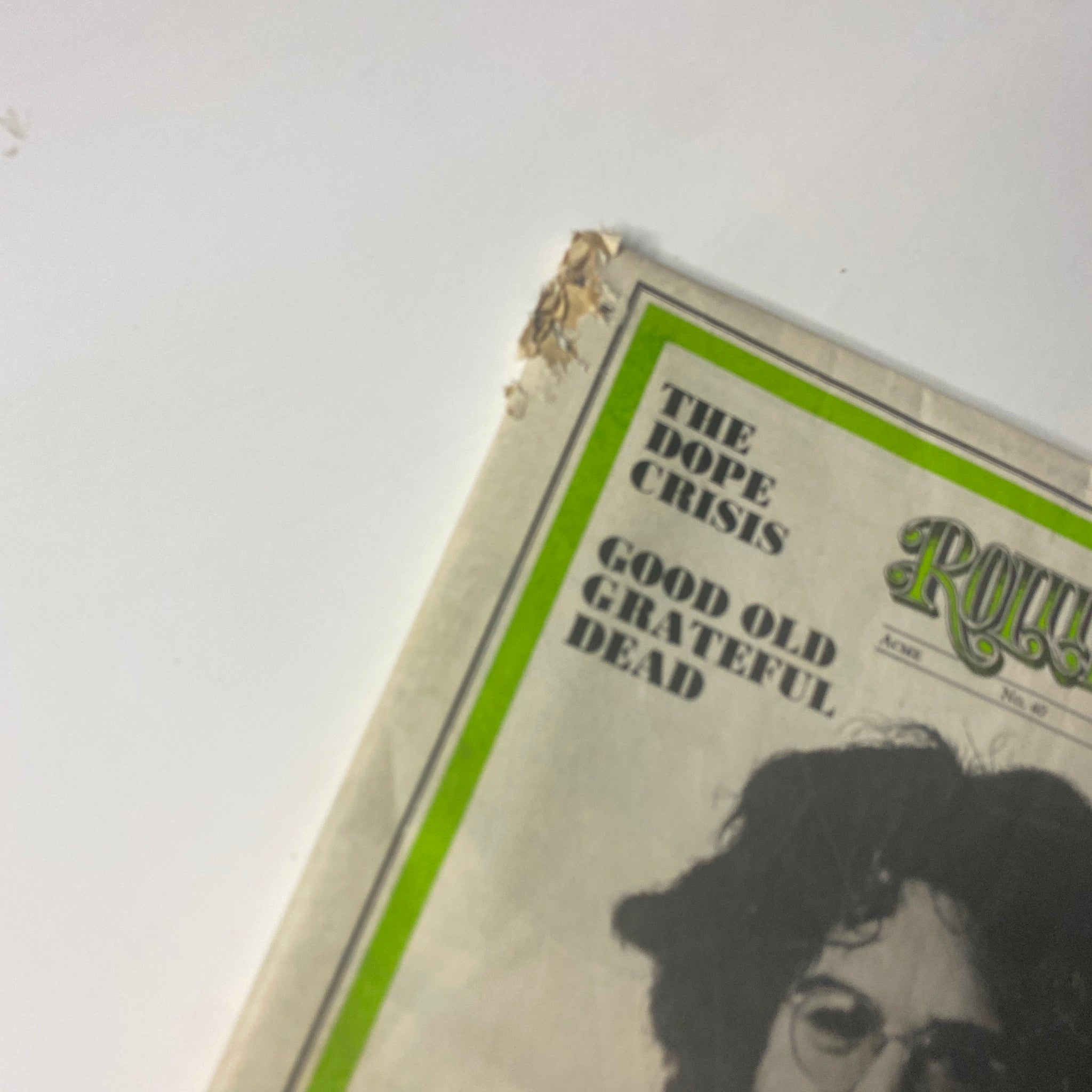Close-up of the corner of Rolling Stone Magazine August 23, 1969 featuring Jerry Garcia on the cover, showing signs of aging with a small tear.