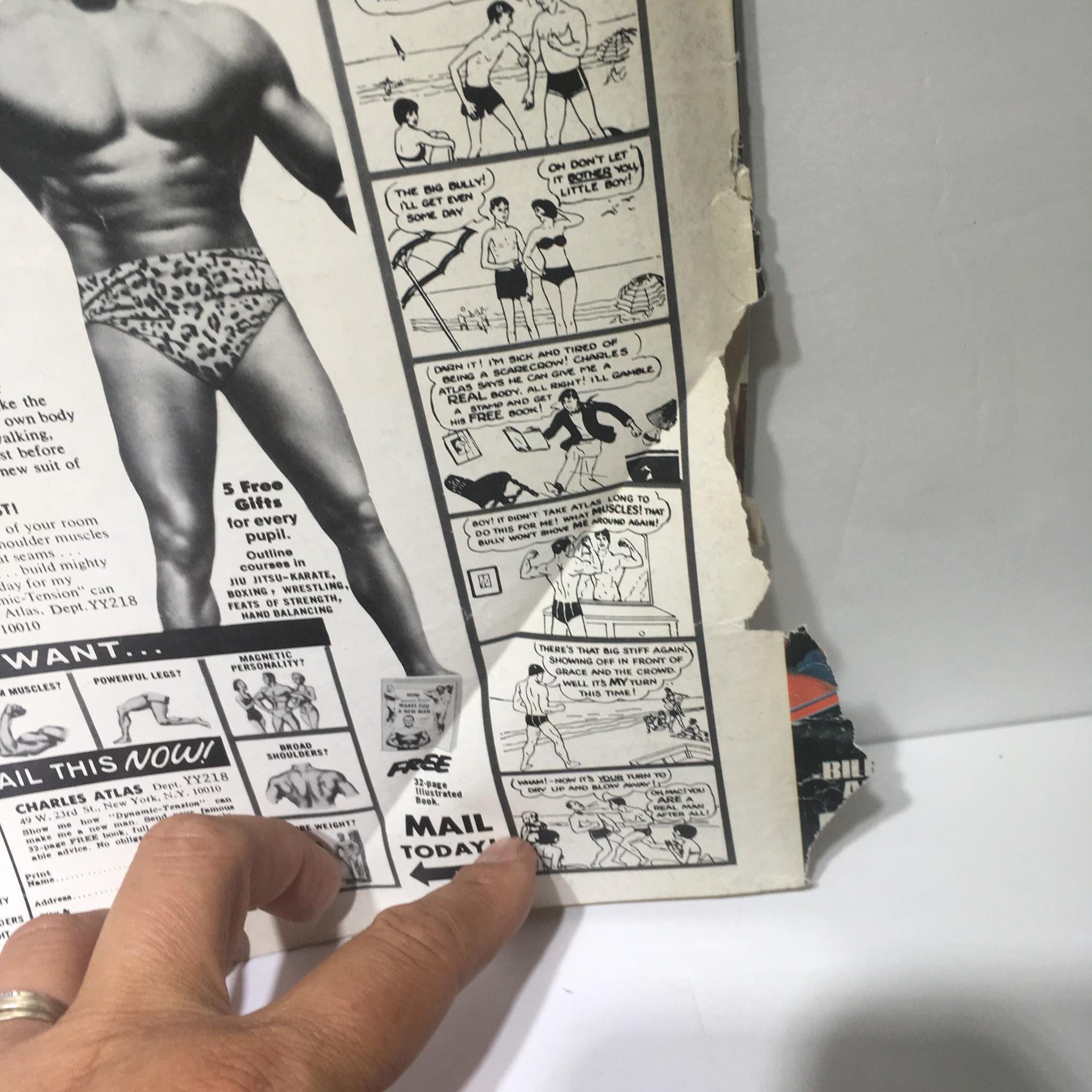 Close-up view of a vintage cartoon segment from The Wrestler Magazine December 1976 featuring humorous depictions related to fitness, alongside an advertisement for Charles Atlas, promoting the magazine that features Terry Funk and Bruno Sammartino.