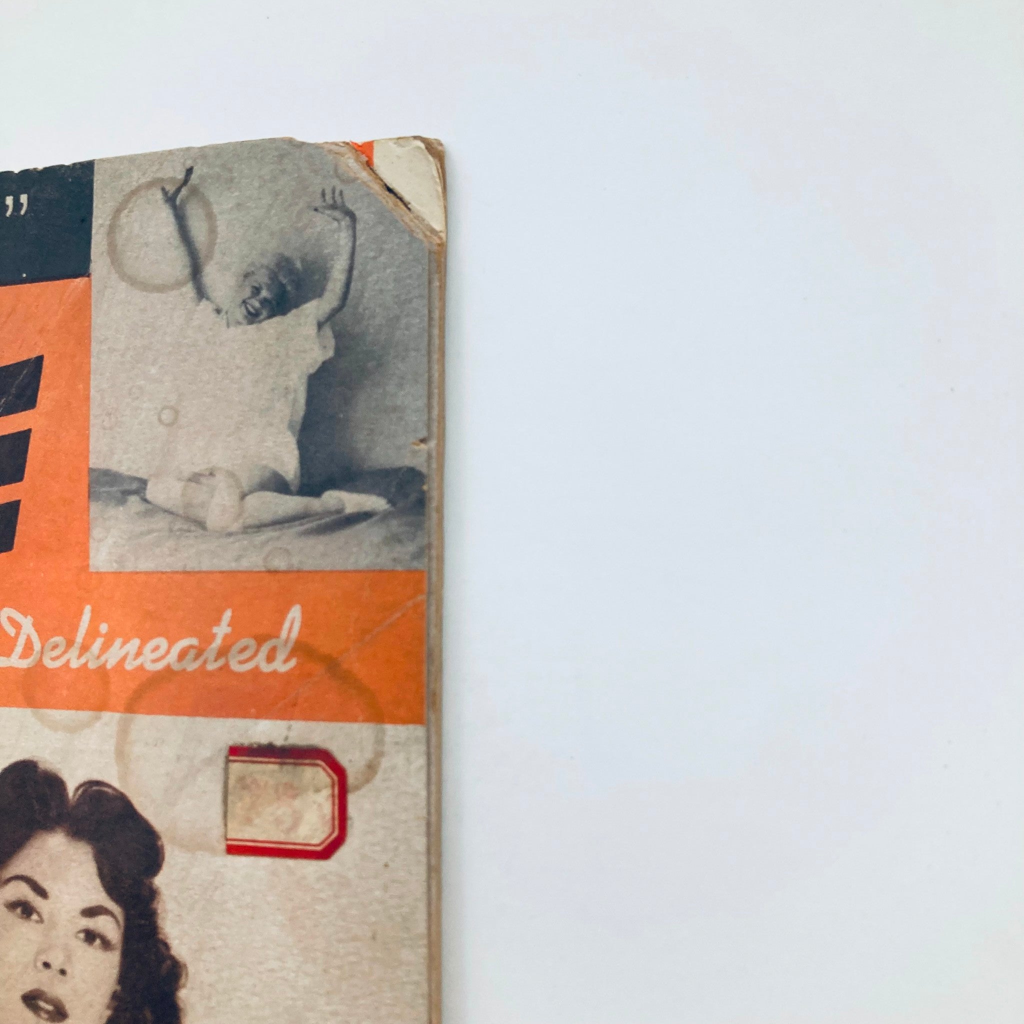 Side view of the VTG Dazzle Adult Magazine 1957 showcasing the magazine's aged cover with a vintage design and artwork.