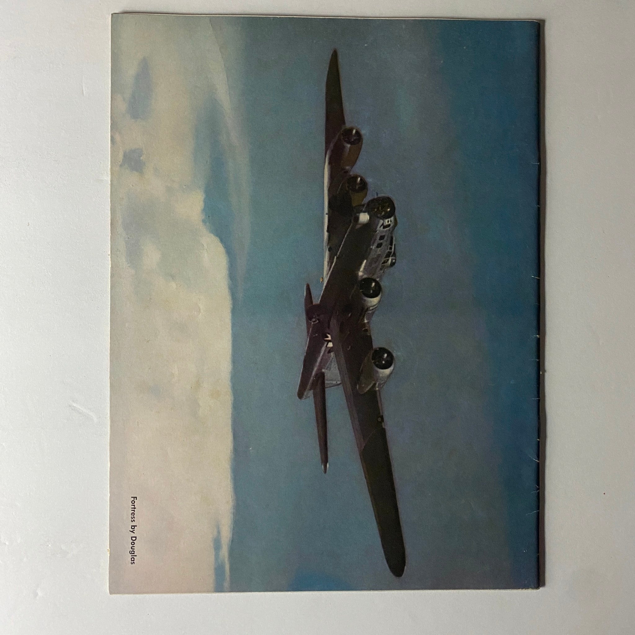 Back cover of Douglas Airview Magazine, May 1944, displaying a vintage aerial view of a military aircraft against a blue sky.