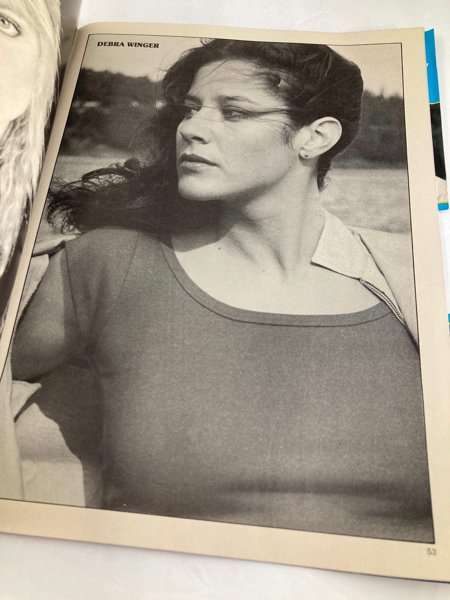 Vintage image of Debra Winger captured in the VTG Hollywood's Sexy Rebels Yearbook 1984; she is styled with a natural look against a backdrop.
