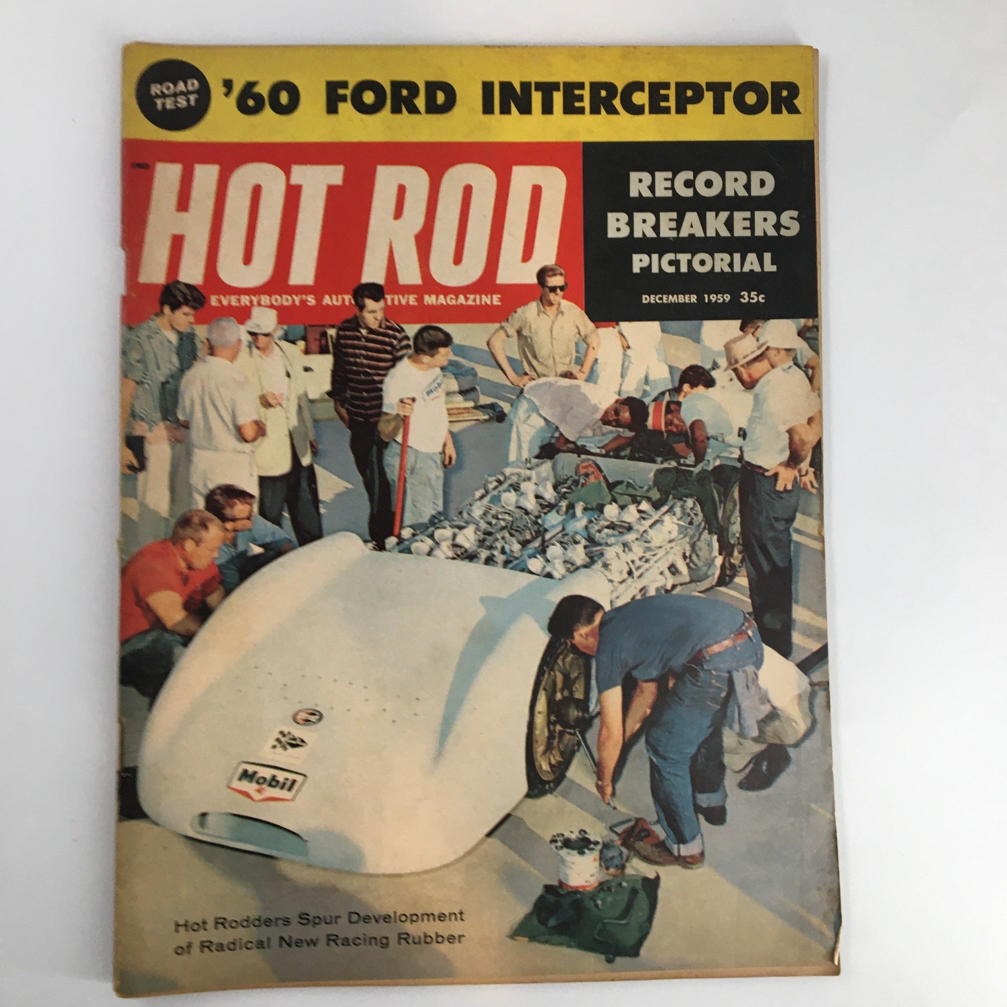 Cover of VTG Hot Rod Magazine December 1959 featuring '60 Ford Interceptor and hot rodders working on a racing vehicle, showcasing the vibrant culture of the mid-20th century hot rod movement.