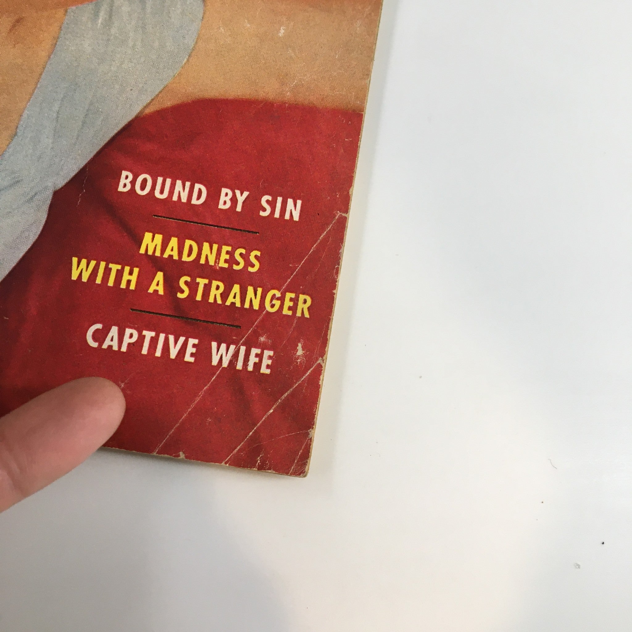 VTG Daring Romances Magazine April 1953 - Close-up of magazine cover showing titles 'Madness with A Stranger' and 'Bound by Sin'.