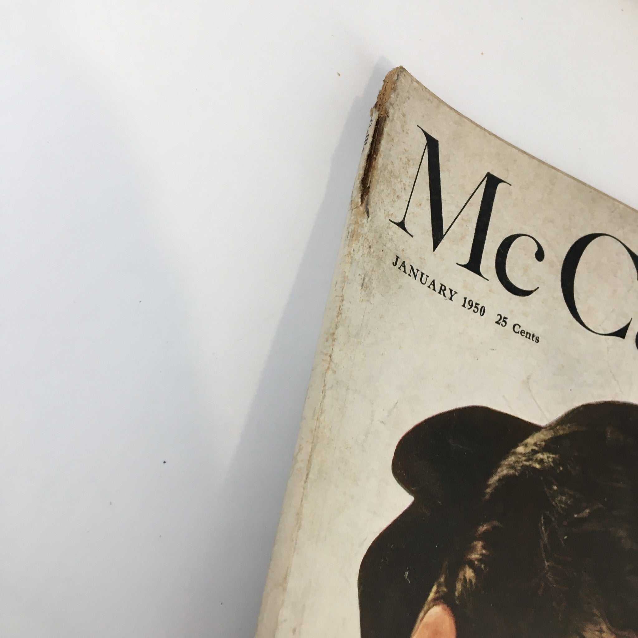 Top view of the cover of VTG McCall's Magazine January 1950, displaying the magazine title and date with a vintage aesthetic.