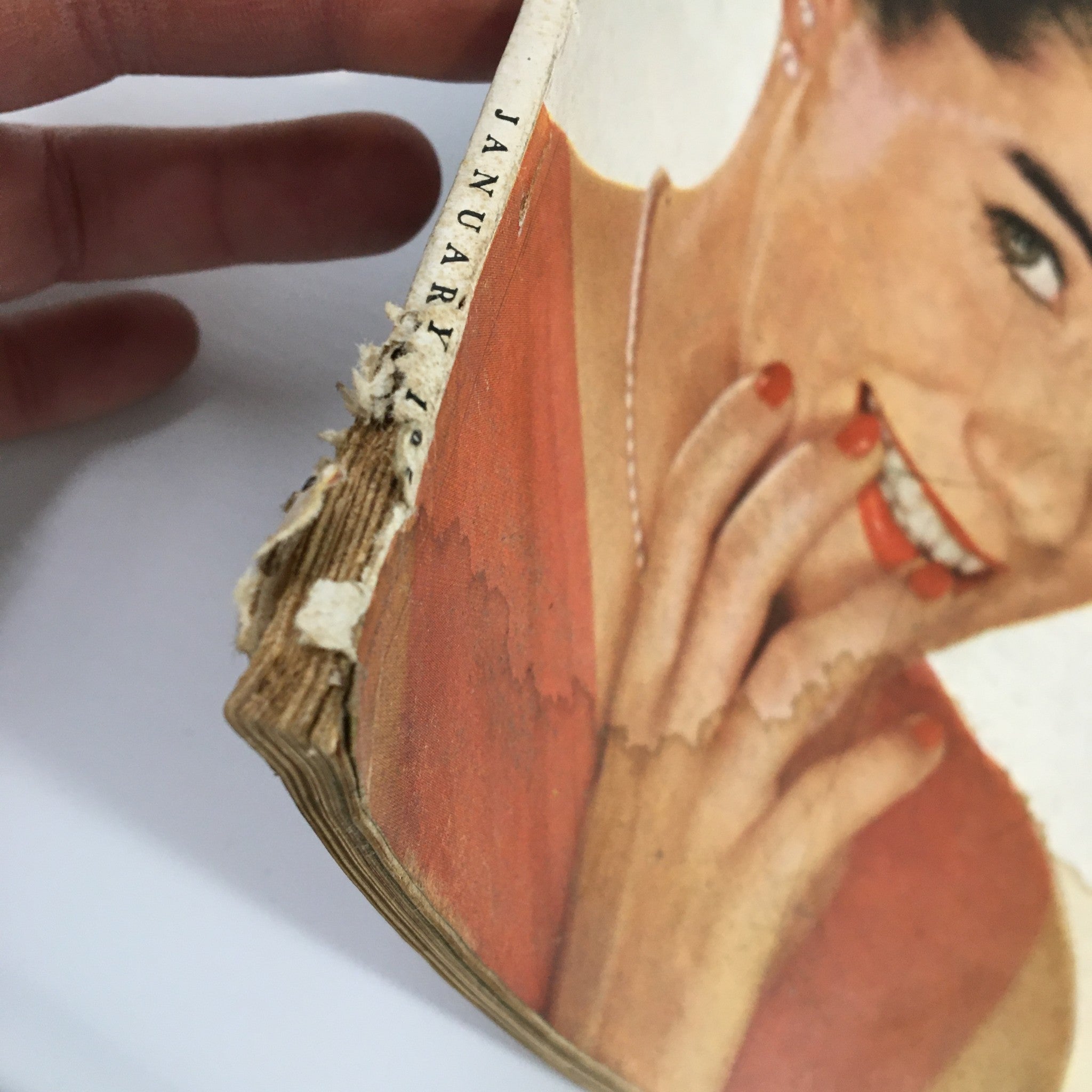 Side view of VTG McCall's Magazine January 1950, showing the spine with a visible date and the magazine's age-related wear.