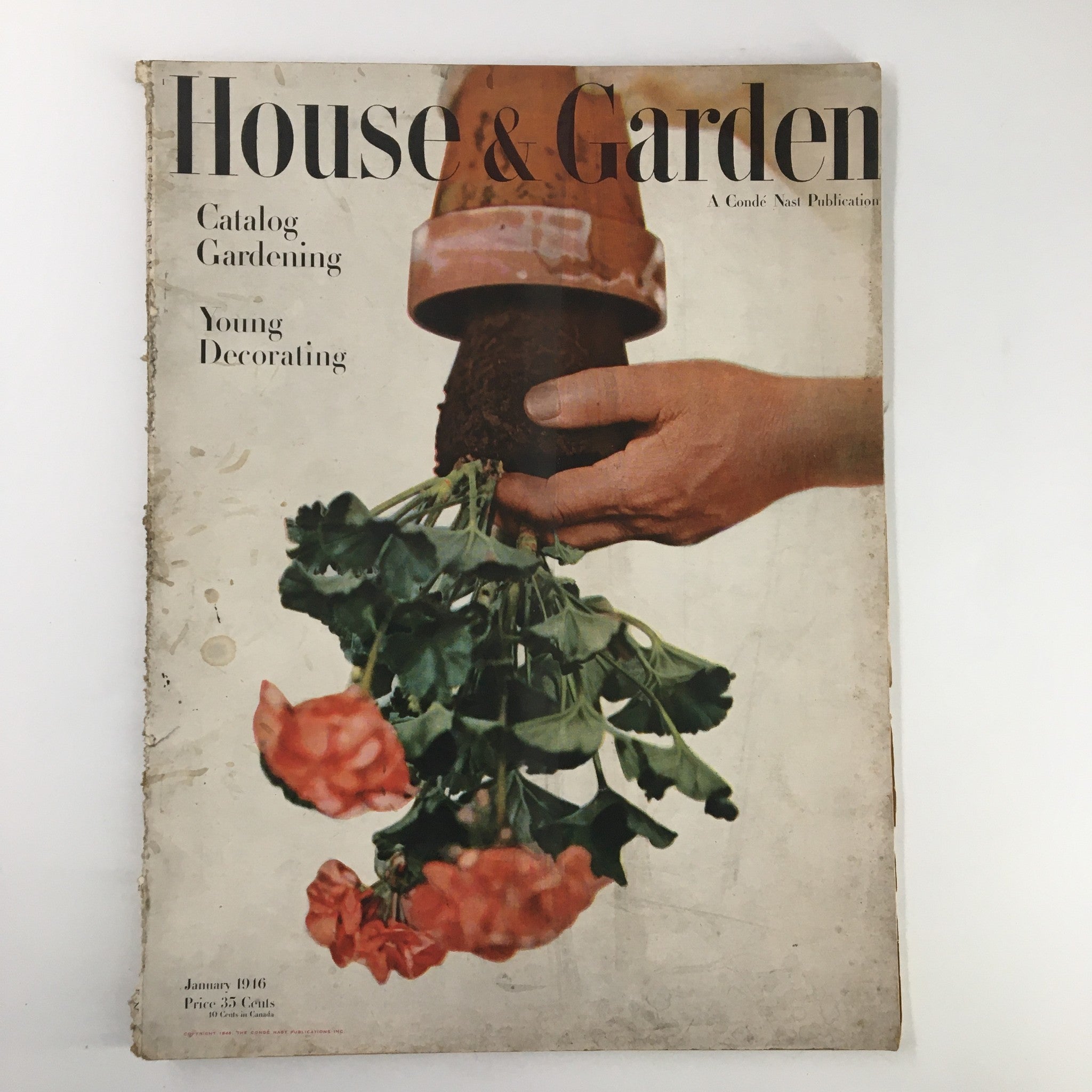 Cover of VTG House & Garden Magazine January 1946 Catalog featuring a hand holding potted geraniums, representing gardening and home decorating.