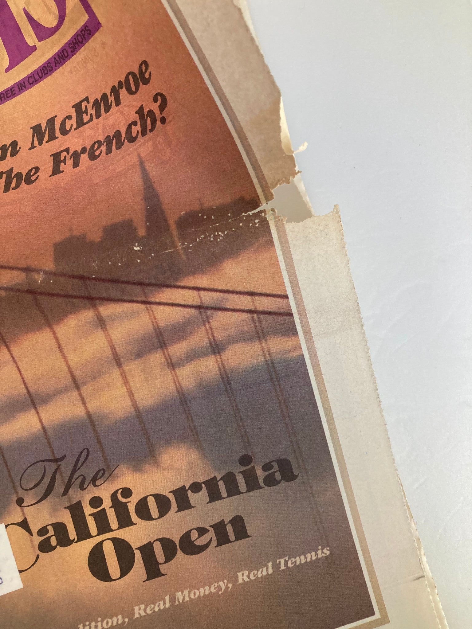 Cover detail of the VTG Inside Tennis Magazine May 1985, featuring the question "Can John McEnroe Win The French?" with a visible tear in the page.