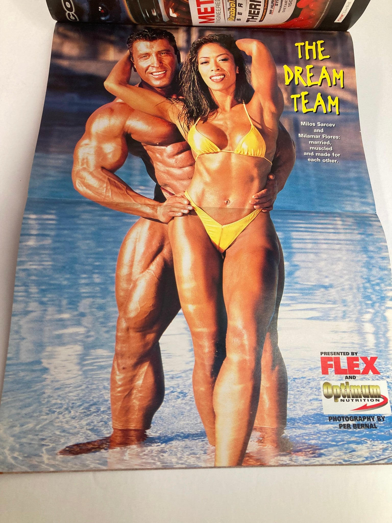 Image from Flex Magazine December 2000 featuring Lee Priest and a model in beachwear, celebrating the theme 'The Dream Team'. This vintage issue highlights bodybuilding culture and features fitness enthusiasts in a stunning coastal setting.