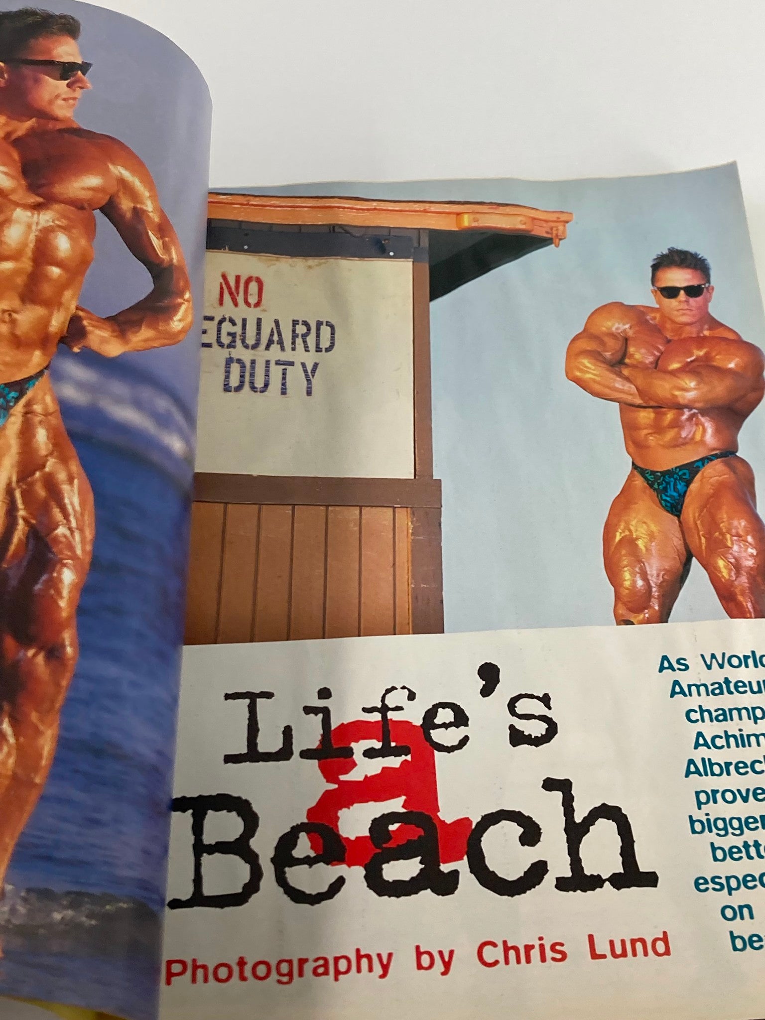 A striking photo from Flex Magazine April 1996 featuring a muscular bodybuilder posing on the beach, promoting fitness aesthetics and strength.