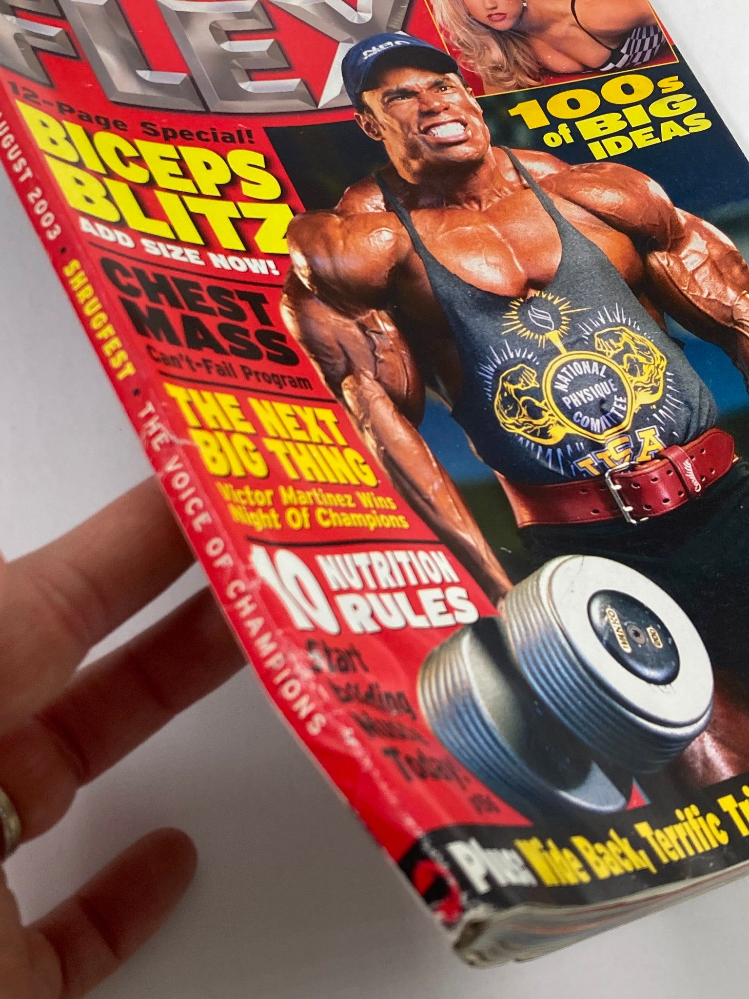 Close-up view of Flex Magazine August 2003 cover, highlighting the muscular male model and the magazine's edge, which displays information on nutrition rules and fitness tips.
