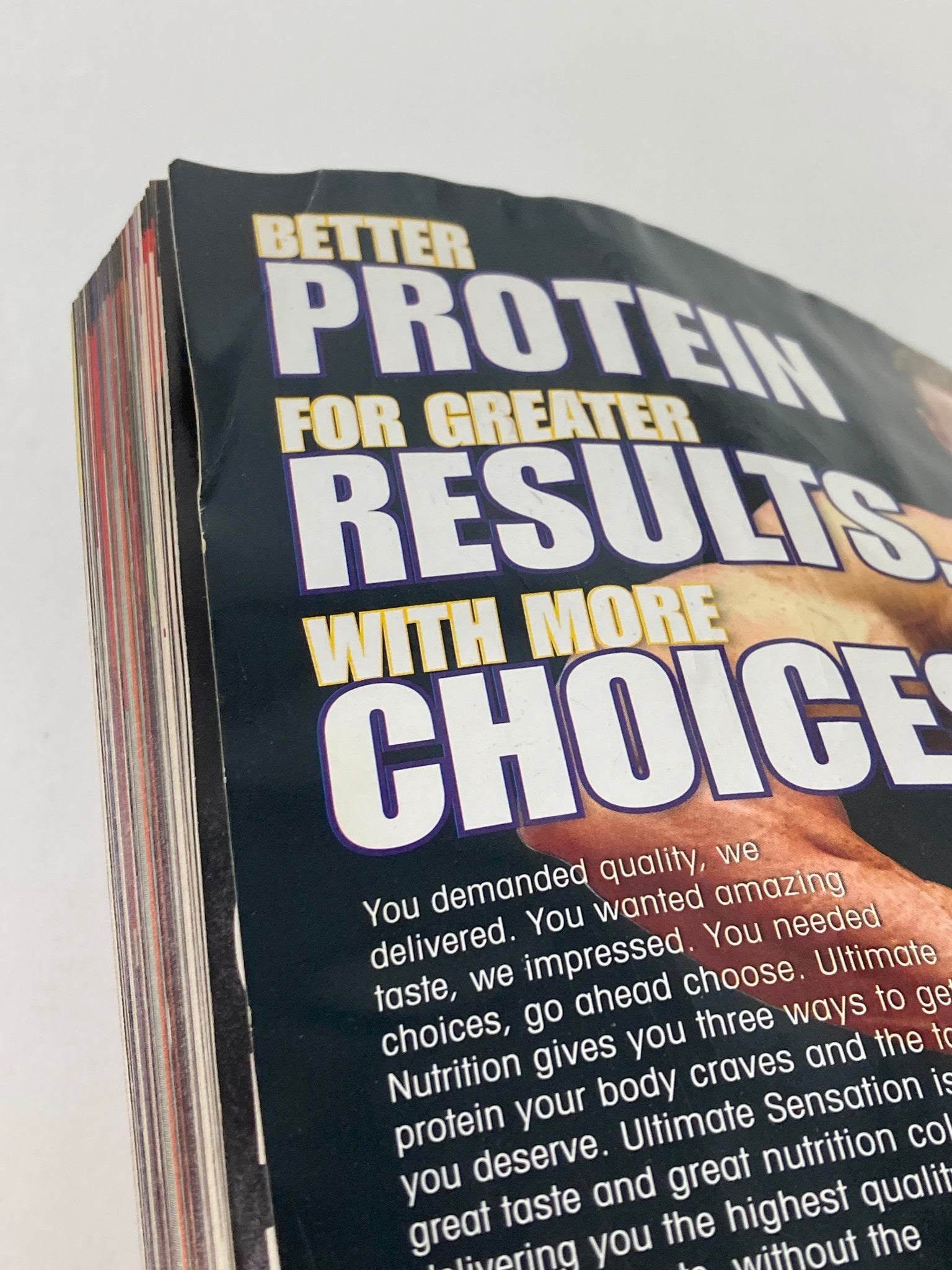 Close-up view of the side pages of Flex Magazine April 2006 featuring headlines like 'Better Protein for Greater Results with More Choices'. This issue highlights fitness and bodybuilding topics, including insights by Branch Warren.