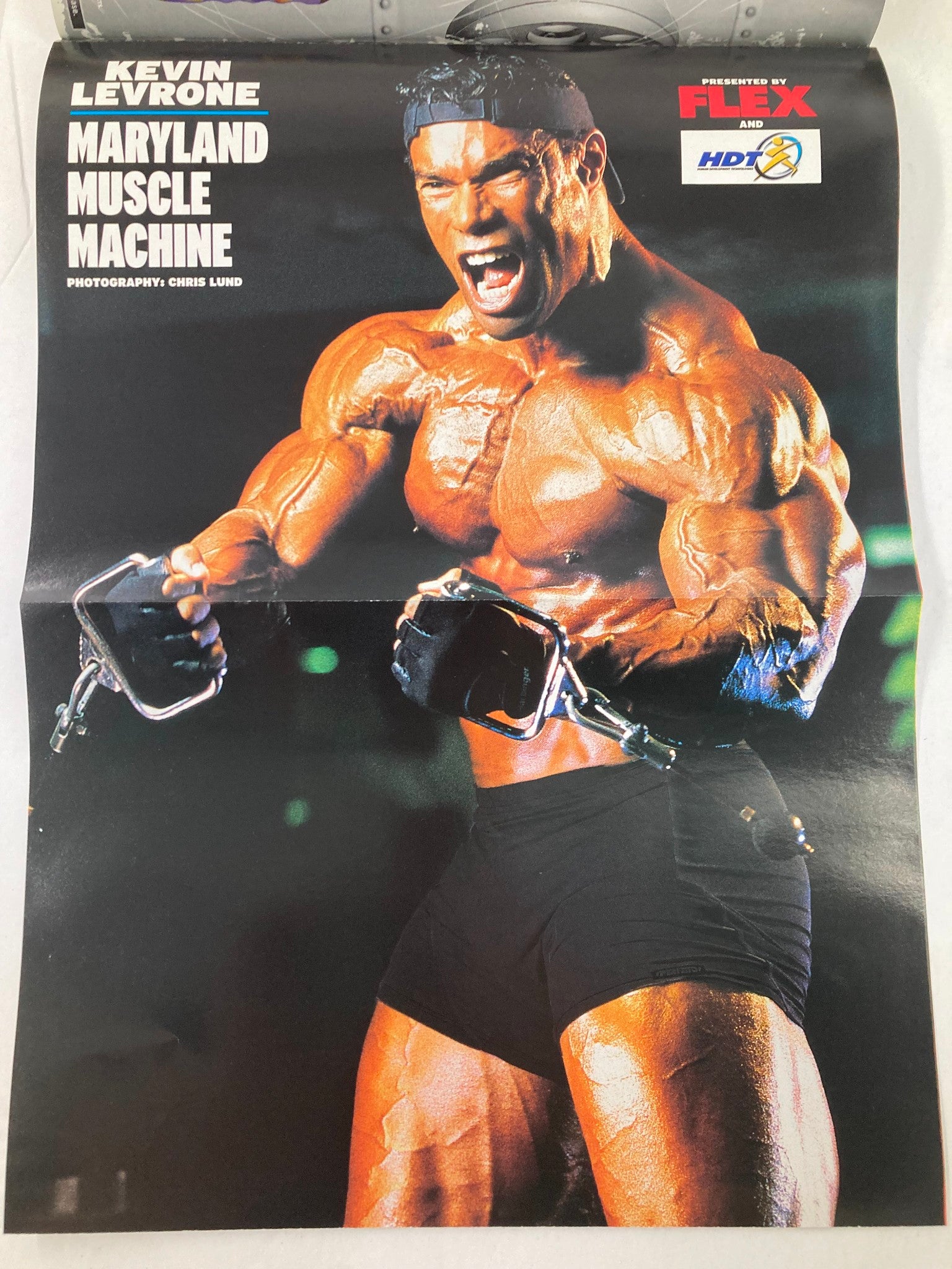 Promotional poster of Kevin Levrone from Flex Magazine September 2002, showcasing his muscular physique and strength as the 'Maryland Muscle Machine'.