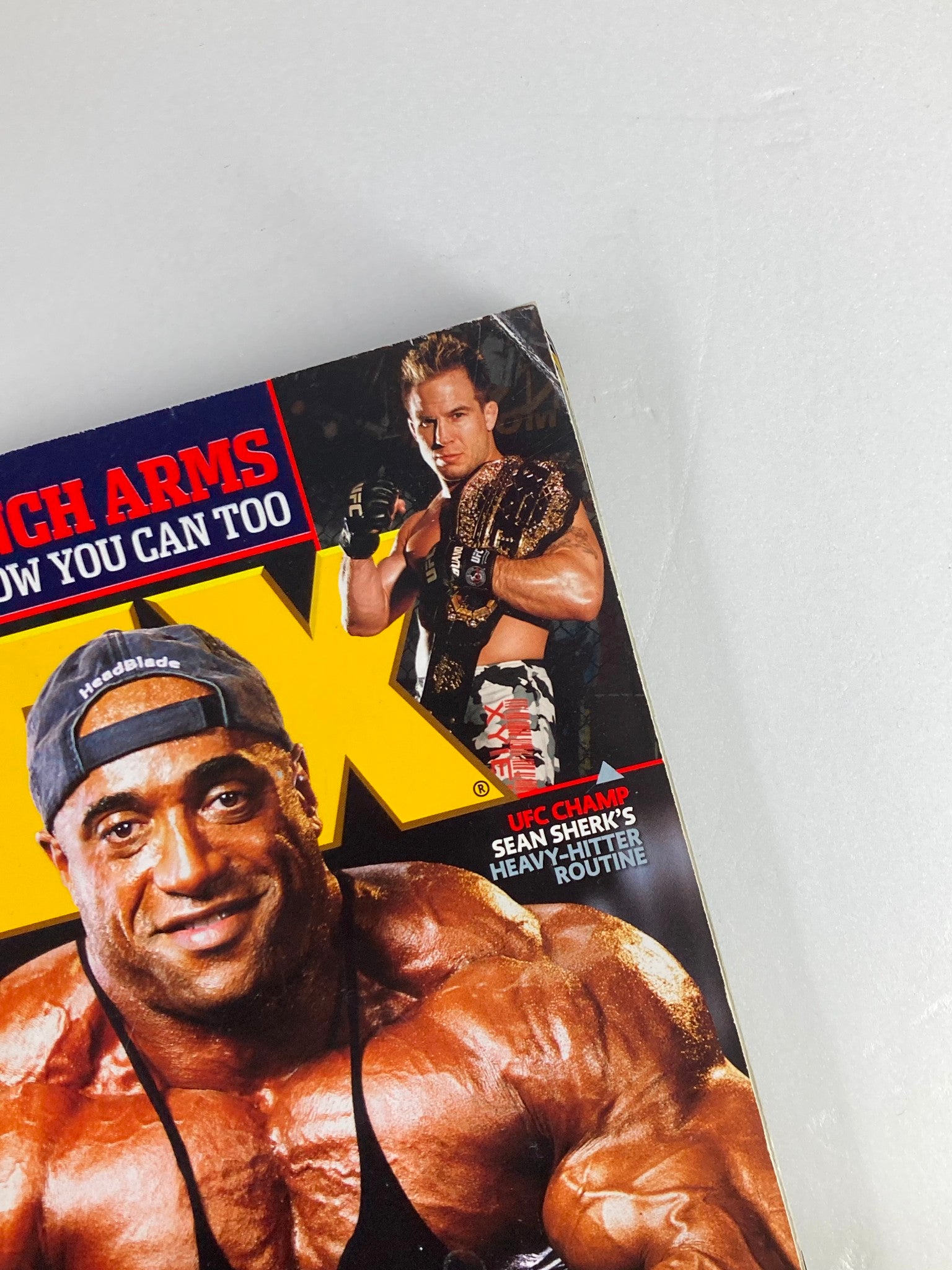Close-up image from Flex Magazine April 2007, featuring Sean Sherk, UFC Champion with a title belt, alongside Phil Heath. This detail reflects the magazine's focus on iconic bodybuilding athletes and their training routines.