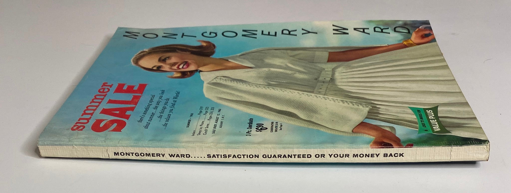 Side view of the 1963 Montgomery Ward Summer Catalog showcasing the cover design and title emphasizing summer sale promotions.