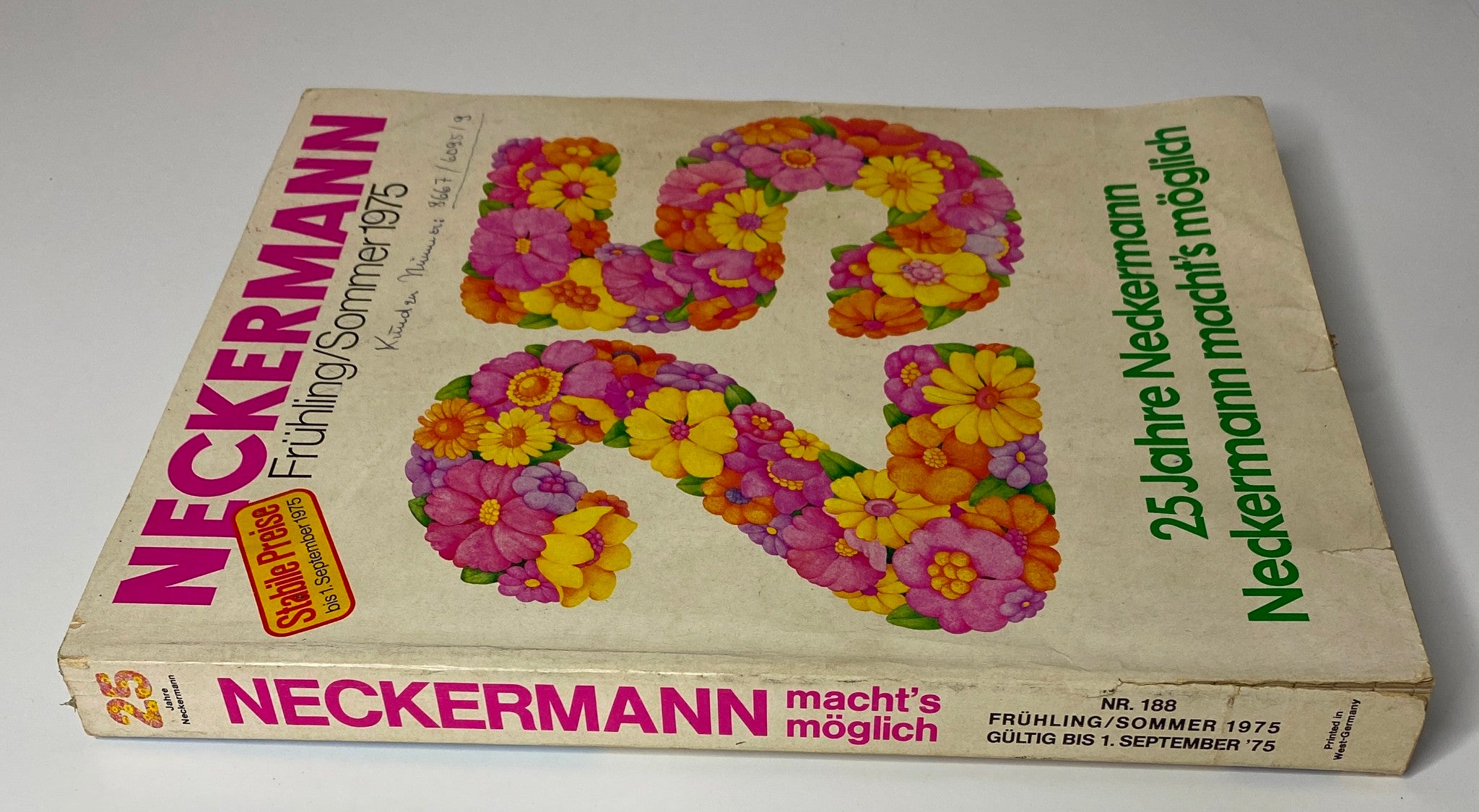 Side view of the 1975 Neckermann Spring and Summer Catalog showing the colorful floral design and detailed title, encapsulating the essence of 1970s fashion and home goods.