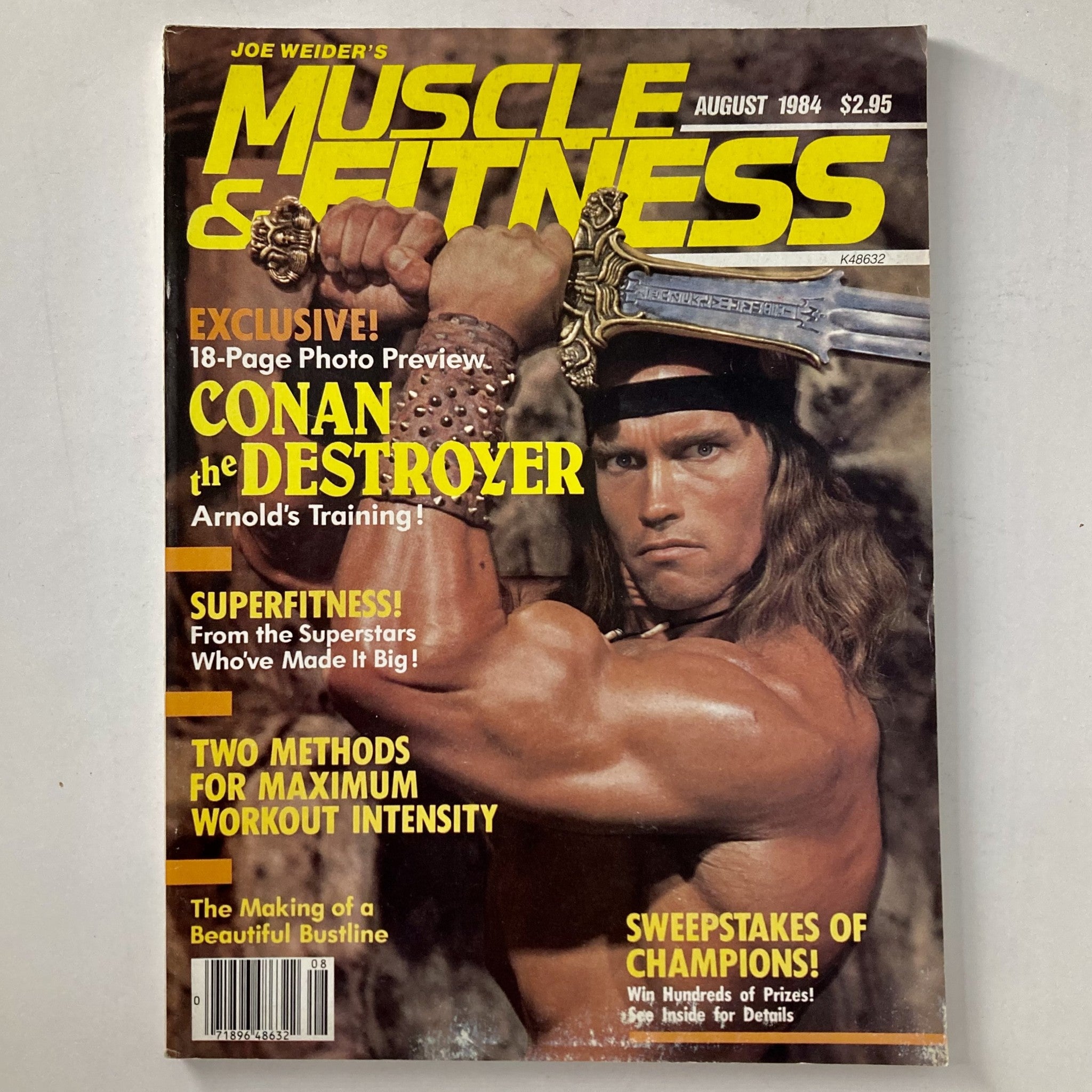 Cover of Joe Weider's Muscle & Fitness Magazine August 1984 featuring Arnold Schwarzenegger with a sword and bodybuilding themes.