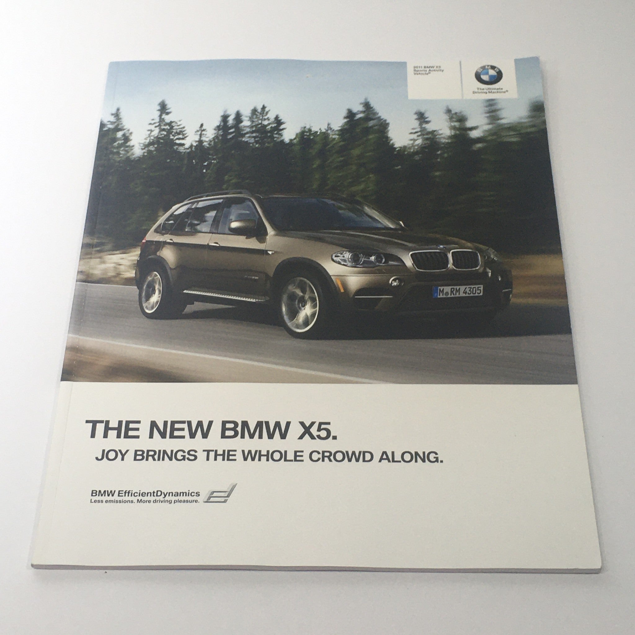 2011 BMW X5 Sports Activity Vehicle Dealership Car Auto Brochure Catalog showcasing the new BMW X5 with a focus on its design and performance in a natural setting.