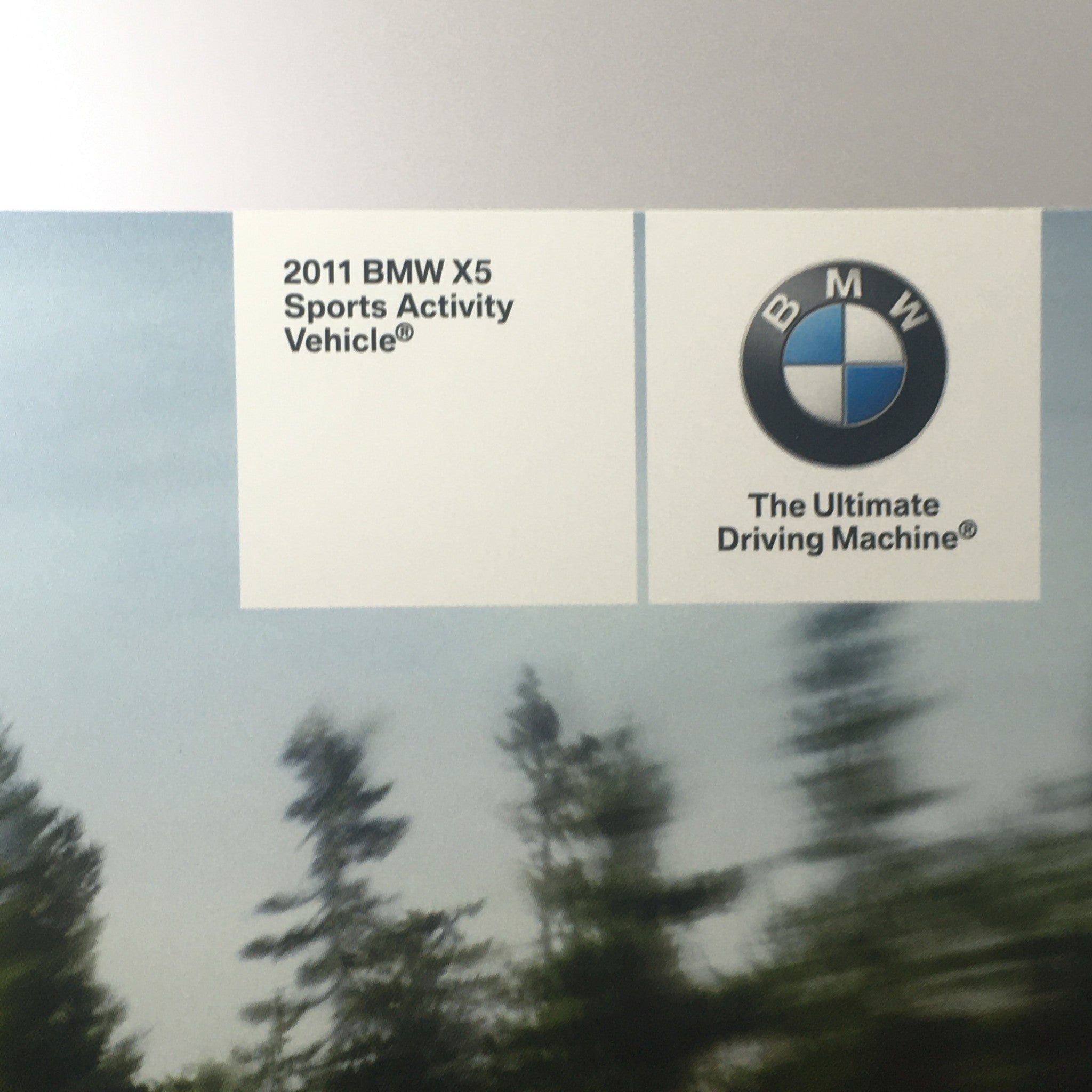 Cover of the 2011 BMW X5 Sports Activity Vehicle Dealership Car Auto Brochure Catalog featuring the BMW logo and tagline 'The Ultimate Driving Machine'.