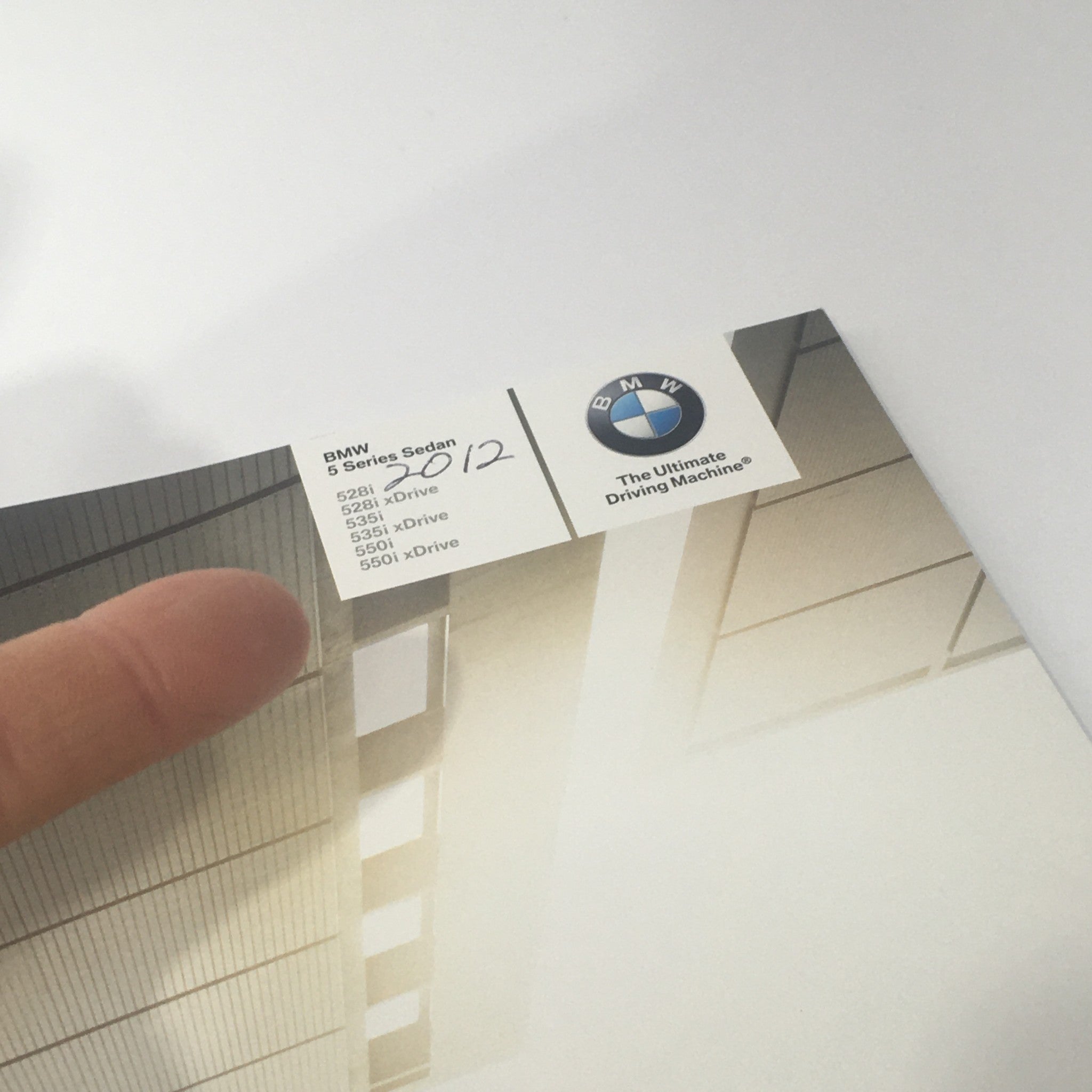 Top corner of the 2012 BMW 5 Series Sedan brochure with model specifications for 528i, 535i, and 550i.
