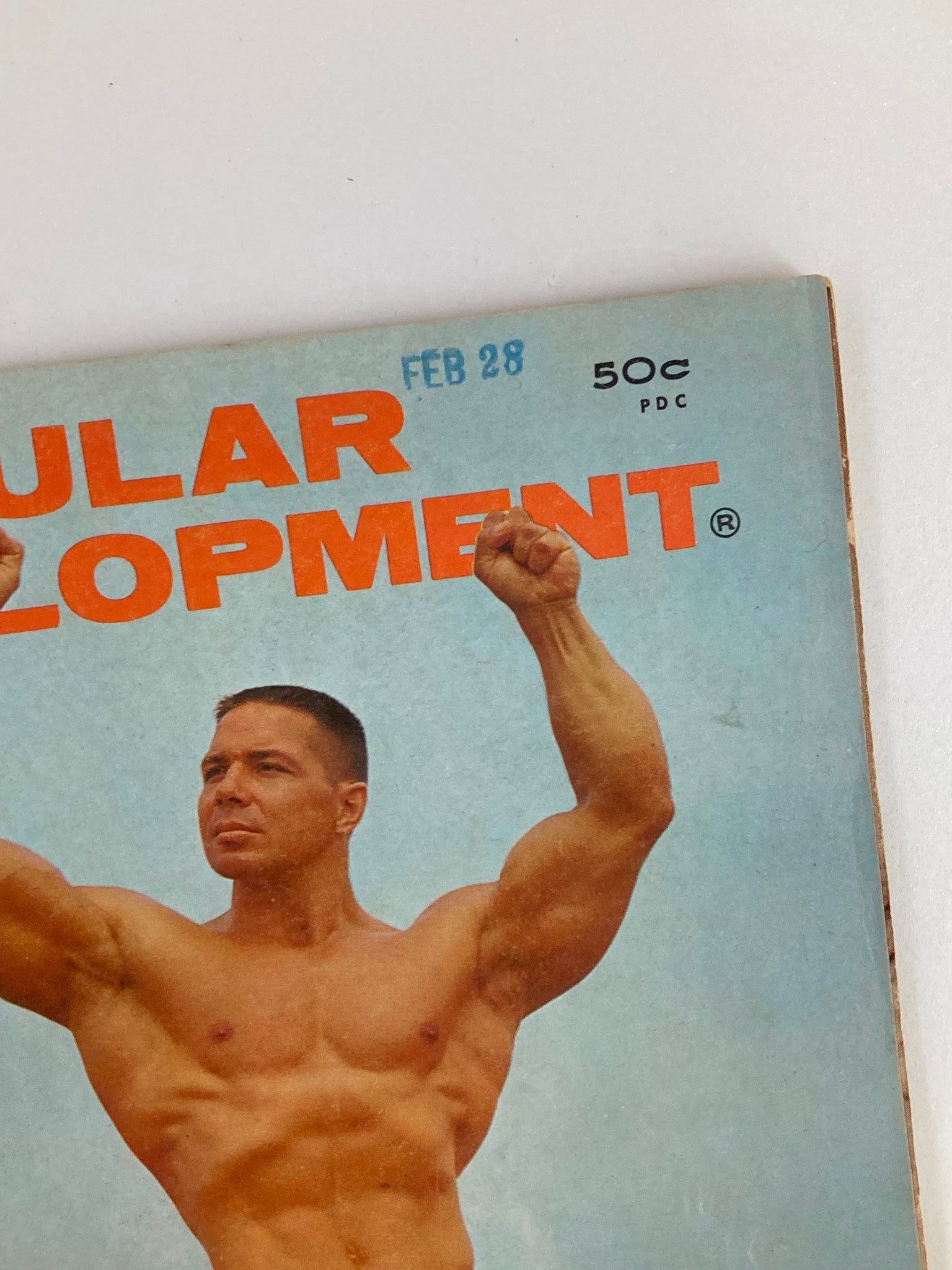 Close-up of the cover header of VTG Muscular Development Magazine April 1966, showcasing the magazine's title and price.