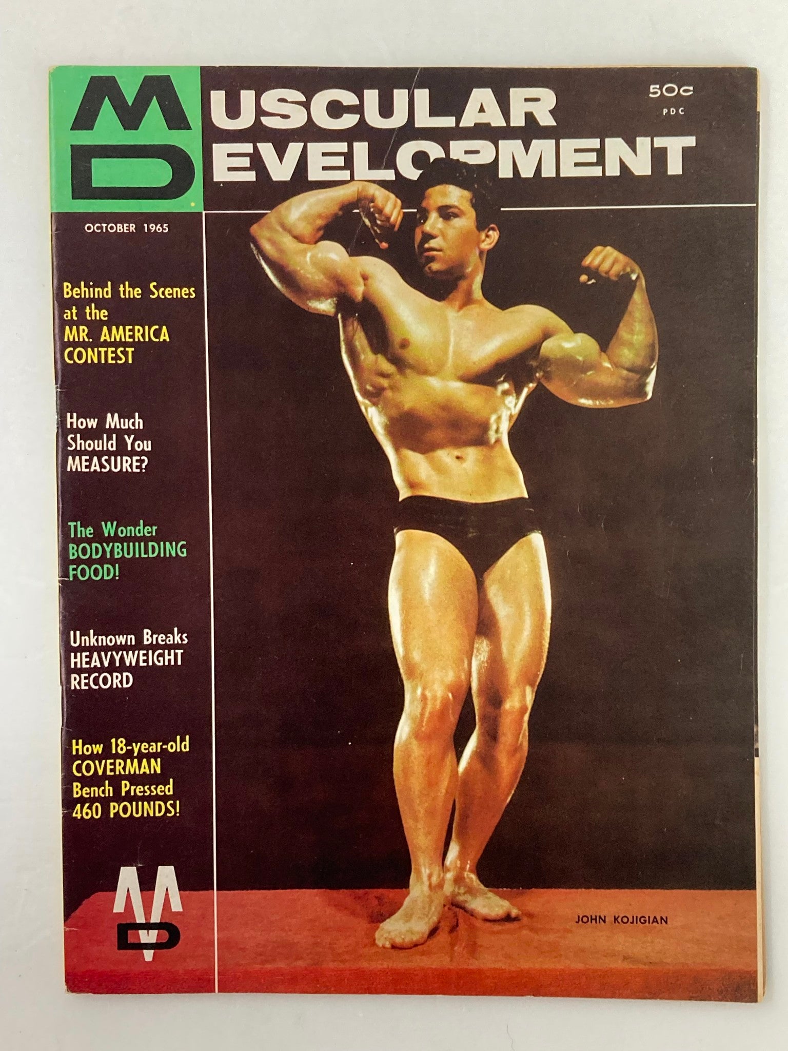 Cover of VTG Muscular Development Magazine October 1965, Volume 2 Issue 10, featuring John Kojigian showcasing bodybuilding poses.