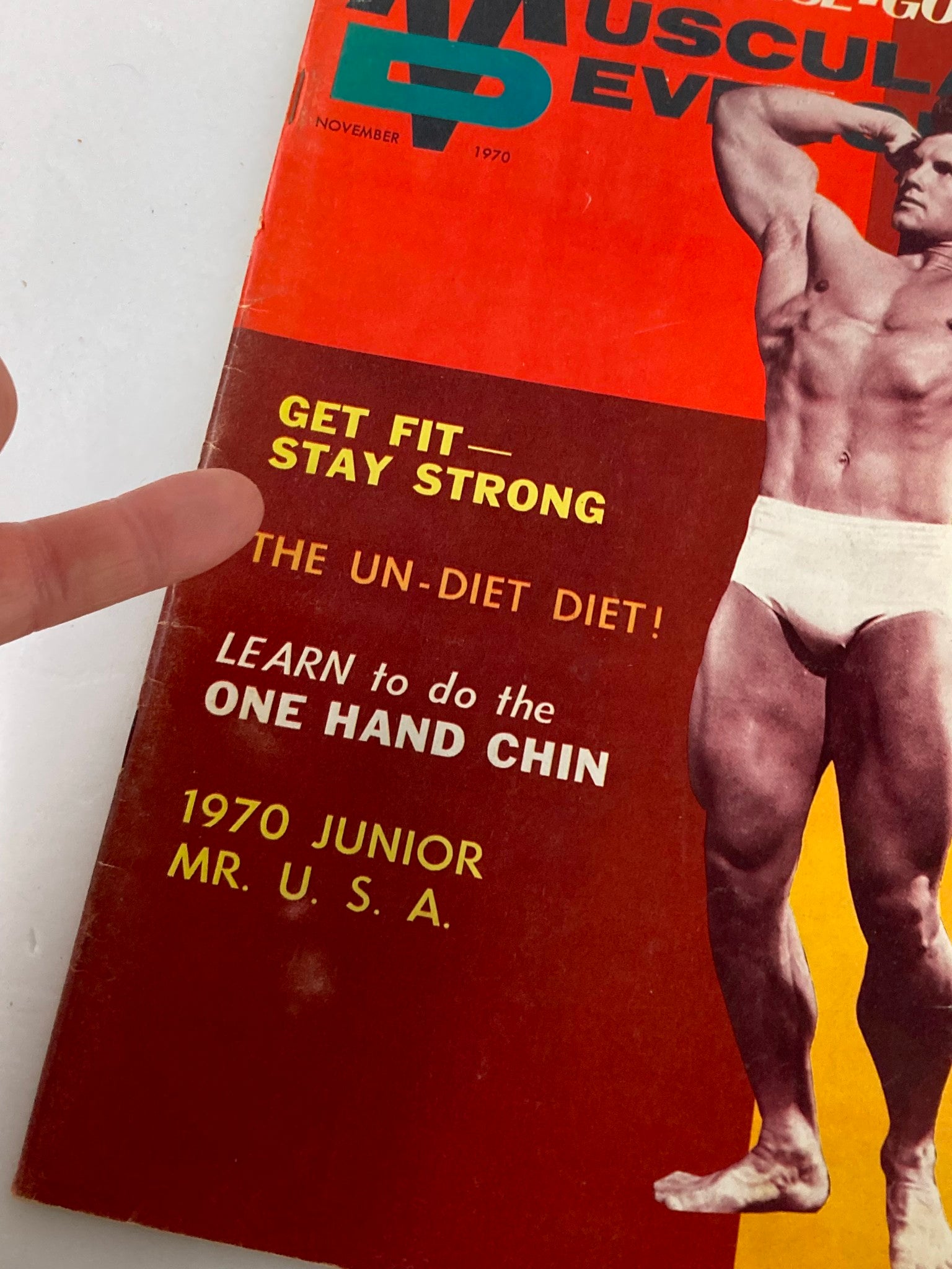 Close-up of VTG Muscular Development Magazine November 1970 Vol 7 #11 cover, highlighting the fitness slogan 'GET FIT — STAY STRONG' and learning tips for the 'ONE HAND CHIN'.