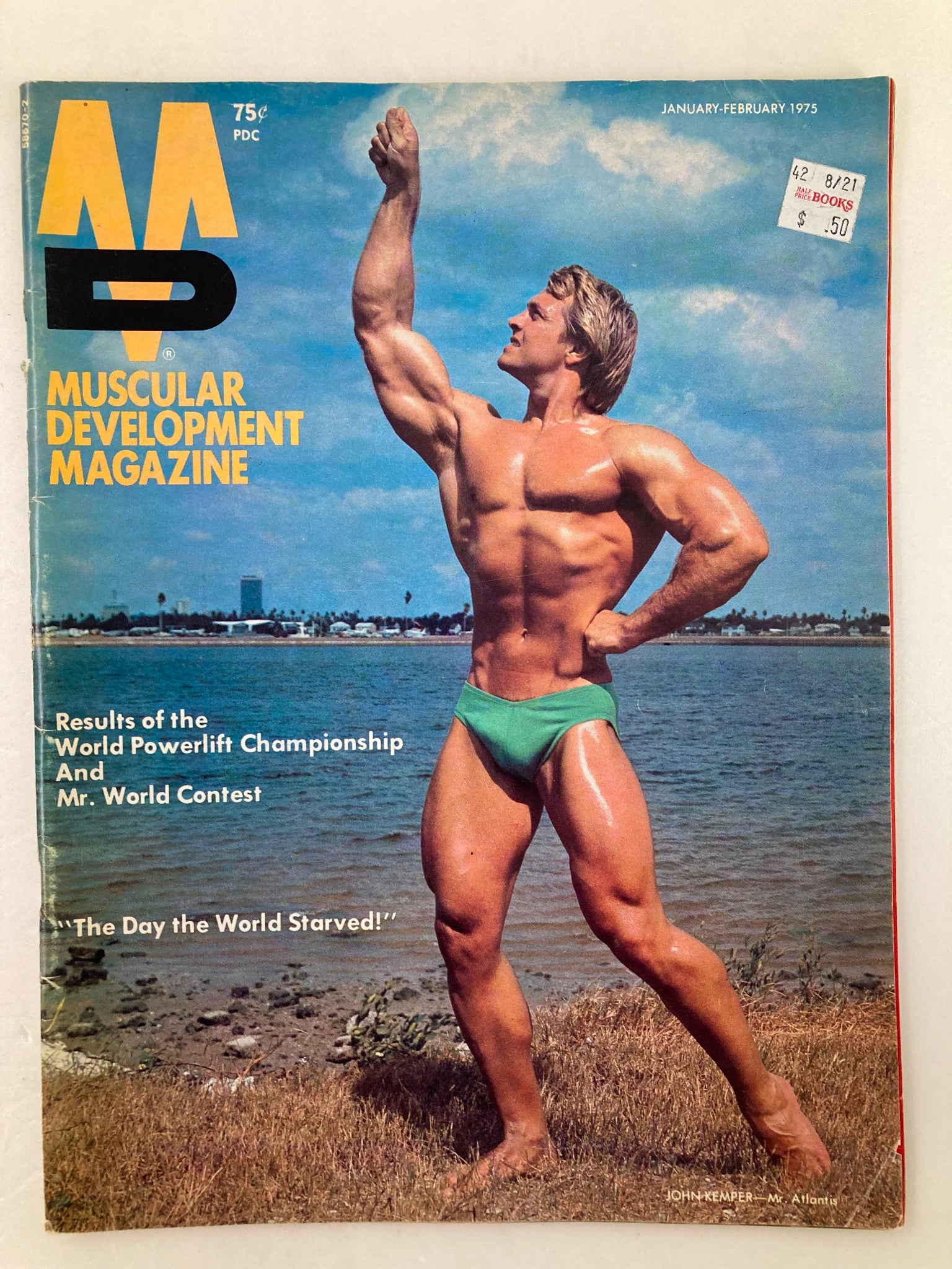 Cover of VTG Muscular Development Magazine January 1975 Vol 12 #1 featuring John Kemper flexing on the beach with a blue sky background.
