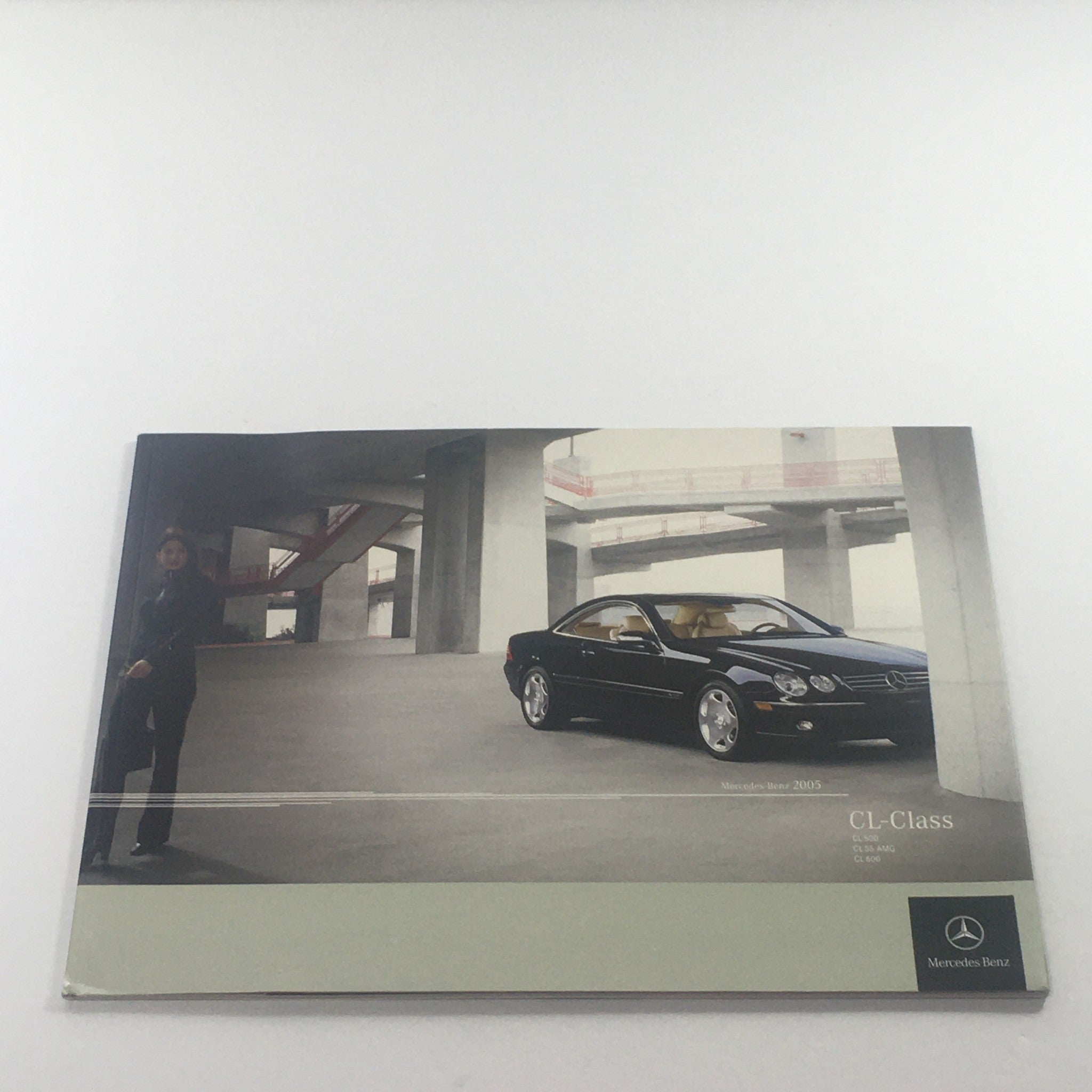 2005 Mercedes-Benz CL-Class 500-55-AMG-600 dealership car auto brochure catalog showcasing the exterior design with a model next to the car.