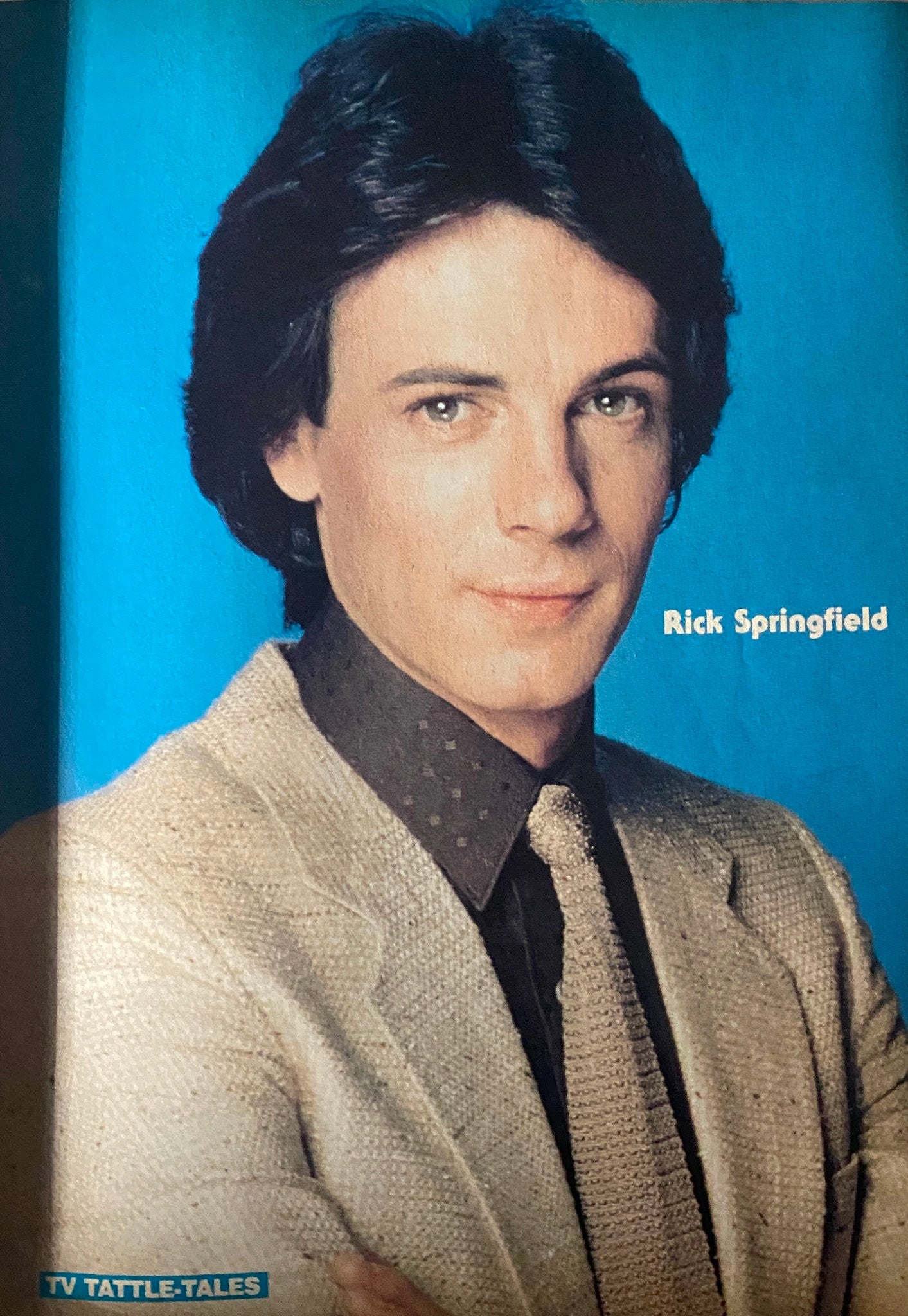Portrait of Rick Springfield featured in 16 Magazine TV & Movie Tattle-Tales Fall 1982, with a blue background.