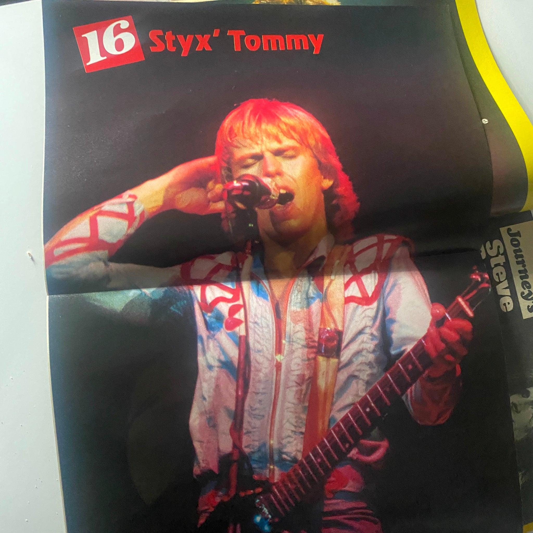 Centerfold poster image from 16 Magazine October 1982 showcasing Styx's Tommy, with vibrant colors and a live performance pose.