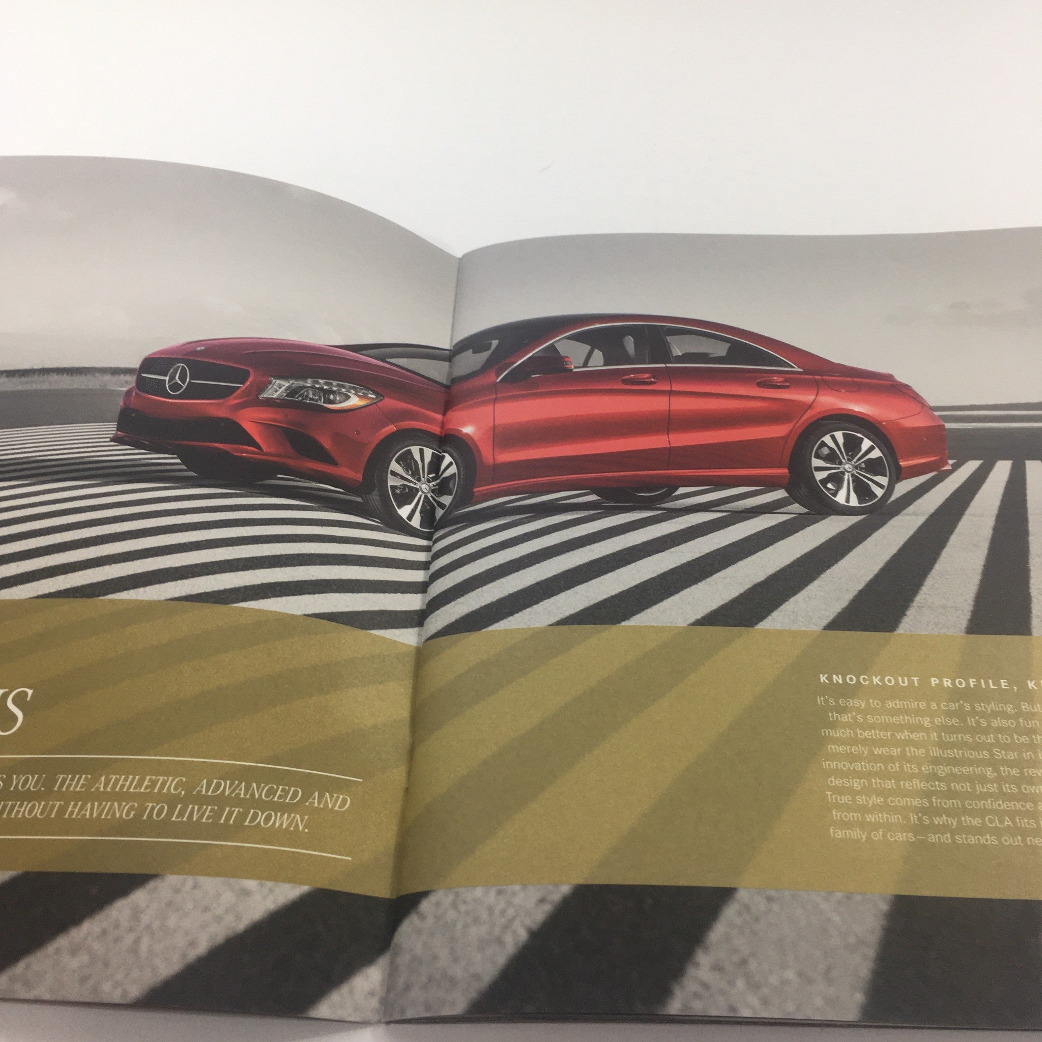 Inside view of the 2016 Mercedes-Benz CLA Dealership Car Auto Brochure showcasing a red CLA car against a modern striped road design.