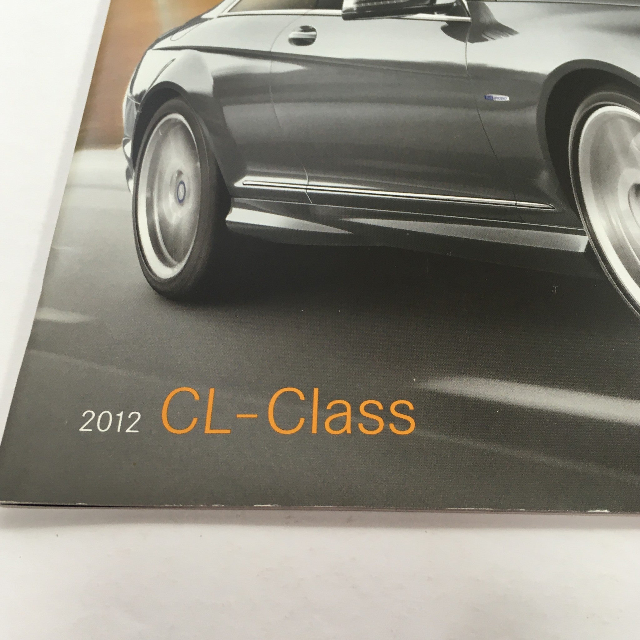 Close-up of the 2012 Mercedes-Benz CL-Class CL550 dealership auto brochure highlighting the CL-Class logo and design details.