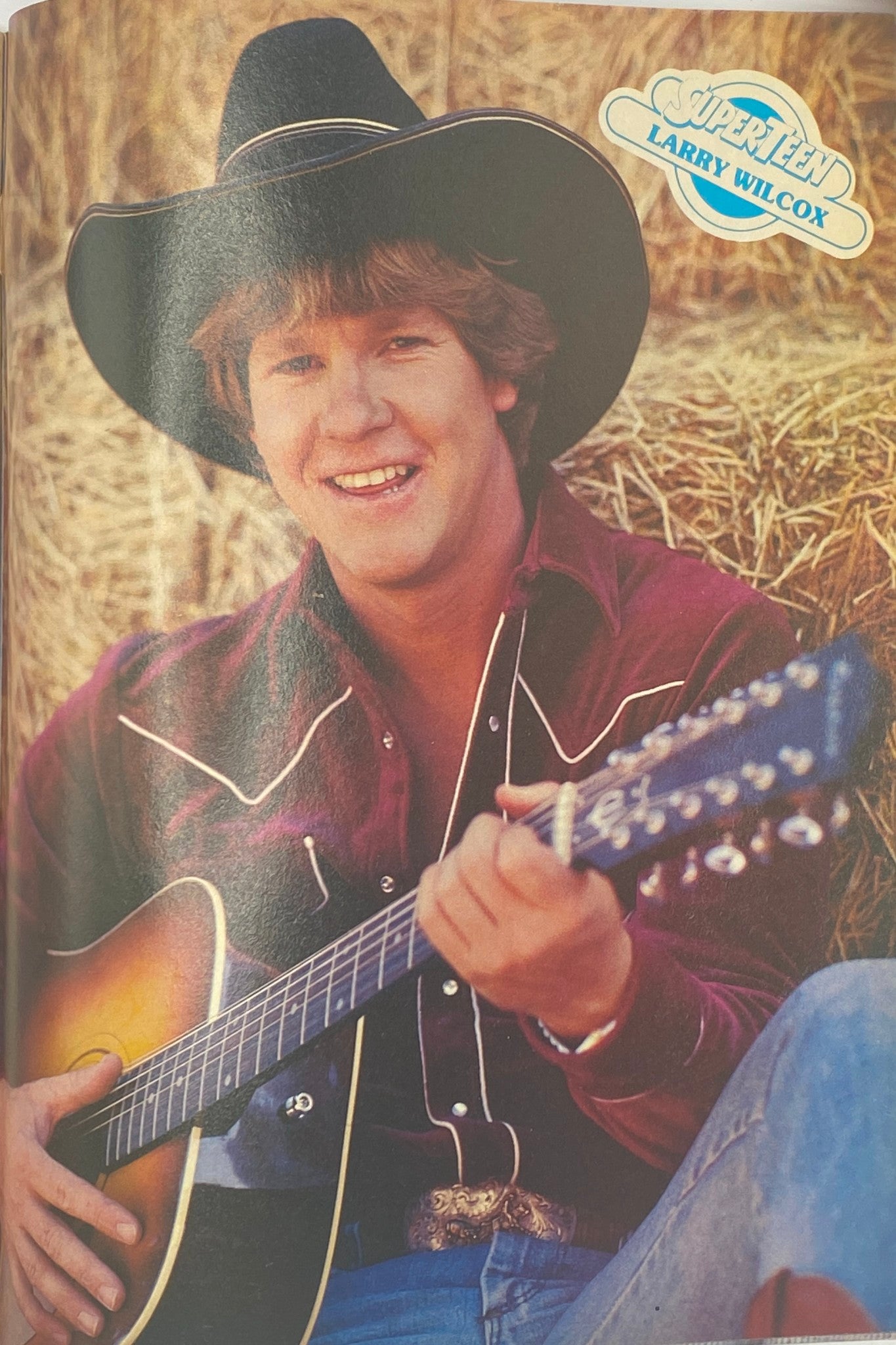 Picture of Larry Wilcox smiling while playing guitar, featured in the September 1980 issue of SuperTeen Magazine, representing classic 80s pop culture.