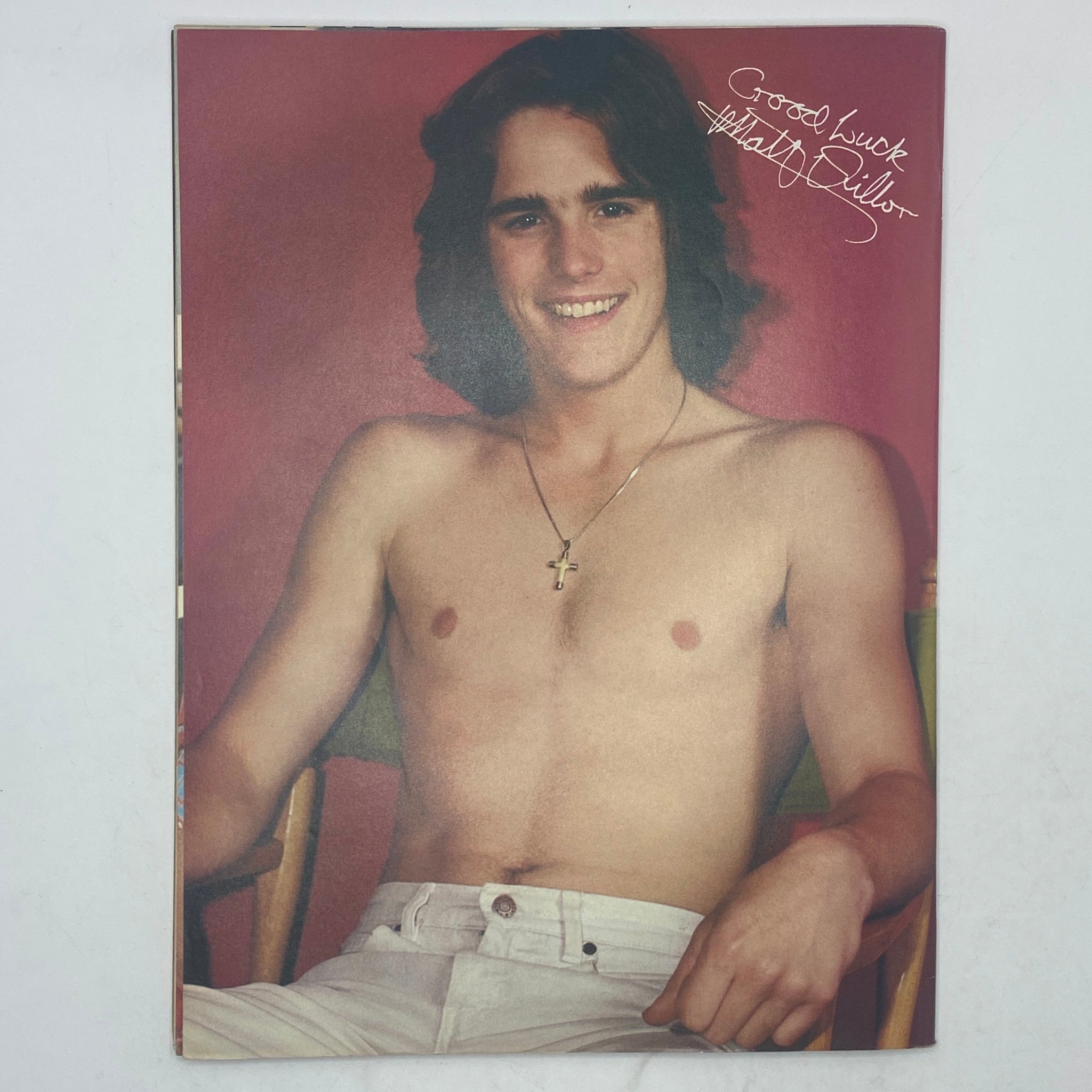 Another classic image from SuperTeen Magazine October 1980, depicting a cheerful young actor, Matt Dillon, shirtless and smiling, with a cross necklace, celebrating the essence of teen magazines in the 1980s.