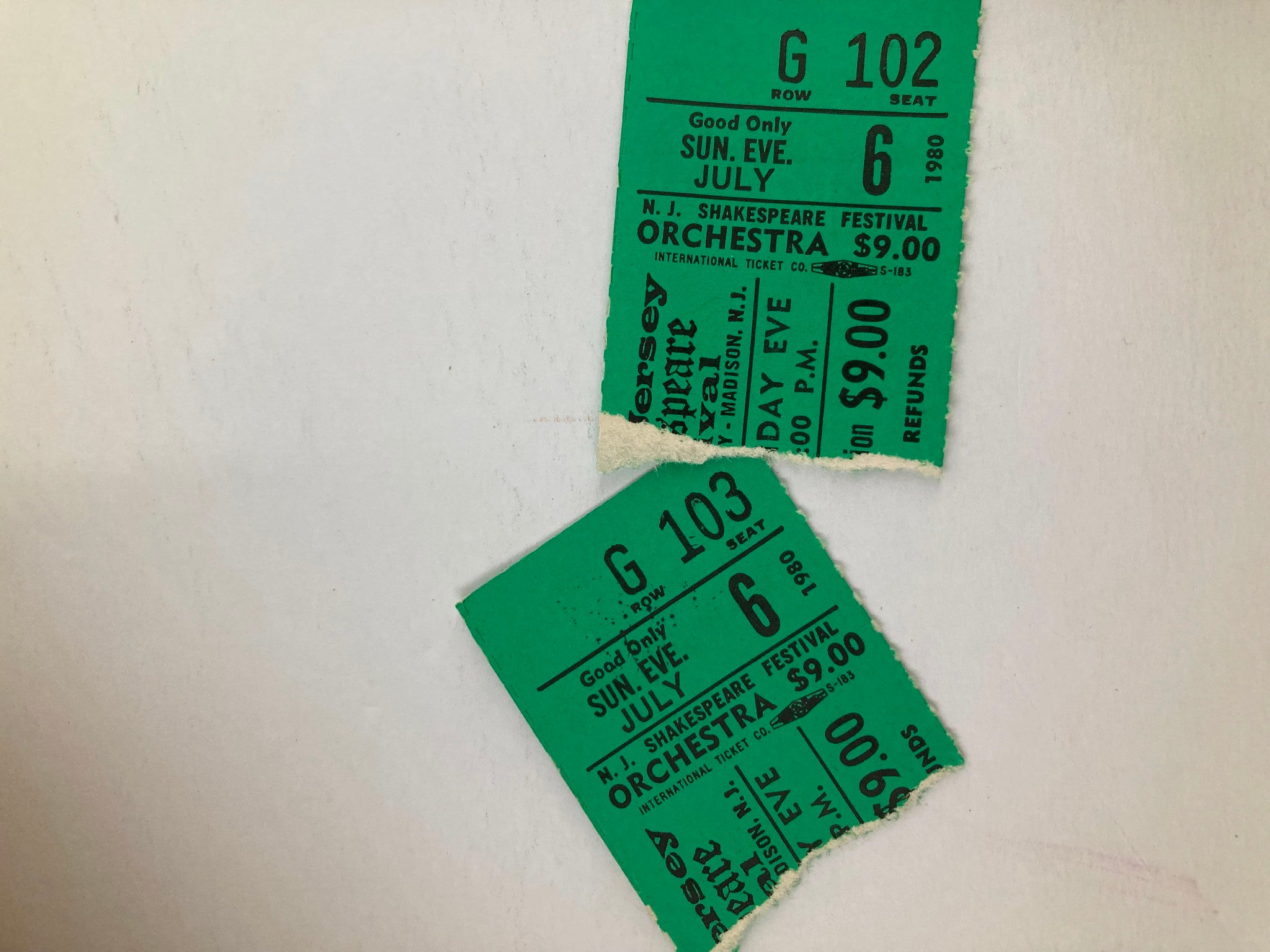 Close-up image of two green ticket stubs from the 1980 New Jersey Shakespeare Festival for the play Volpone, featuring performance details.