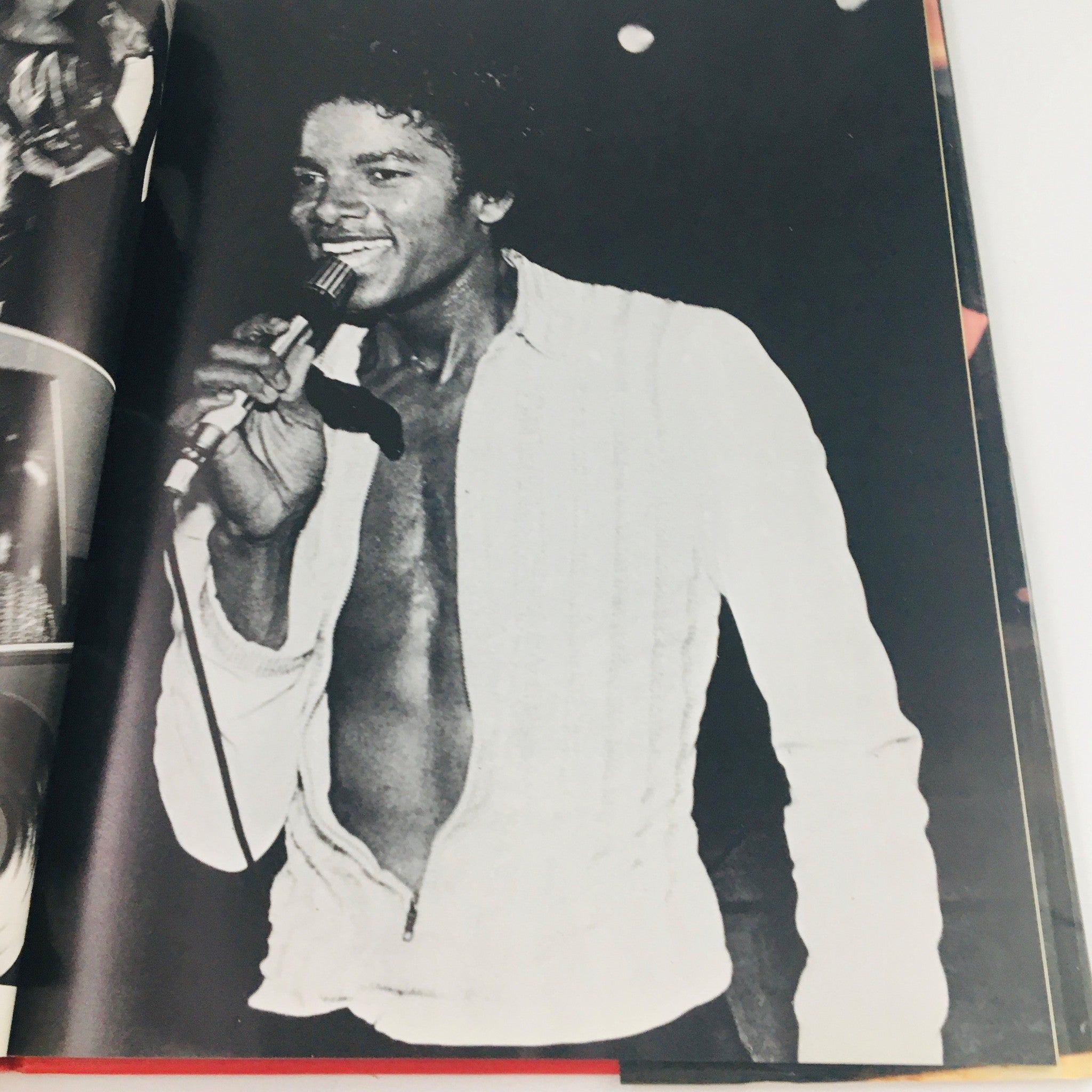 Black and white photo of Michael Jackson performing with a microphone, from 'Greenwich House 1984 Presents Michael Jackson by Stewart Regan'.