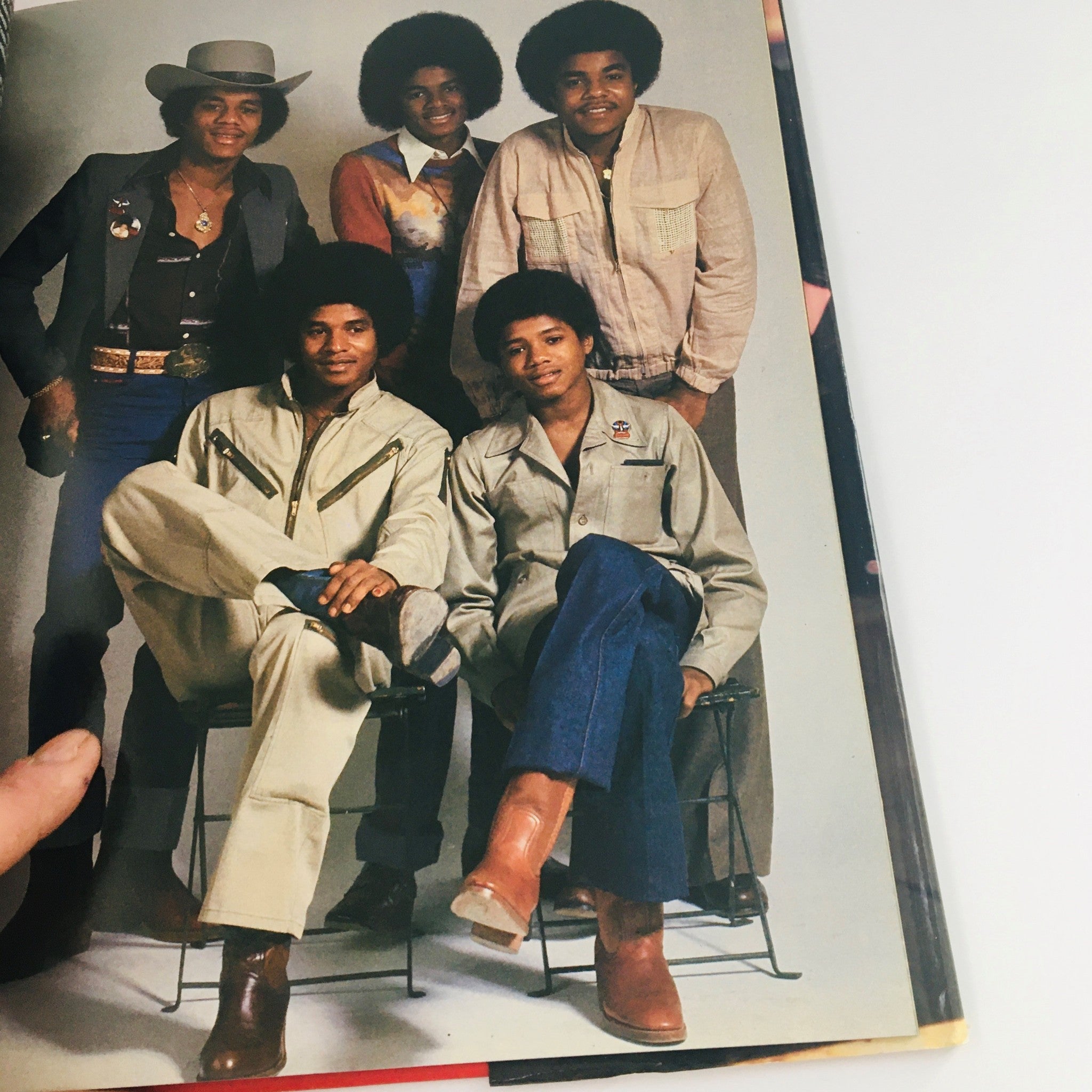 Group photo of Michael Jackson with family members, showcasing a 1970s style, from 'Greenwich House 1984 Presents Michael Jackson by Stewart Regan'.
