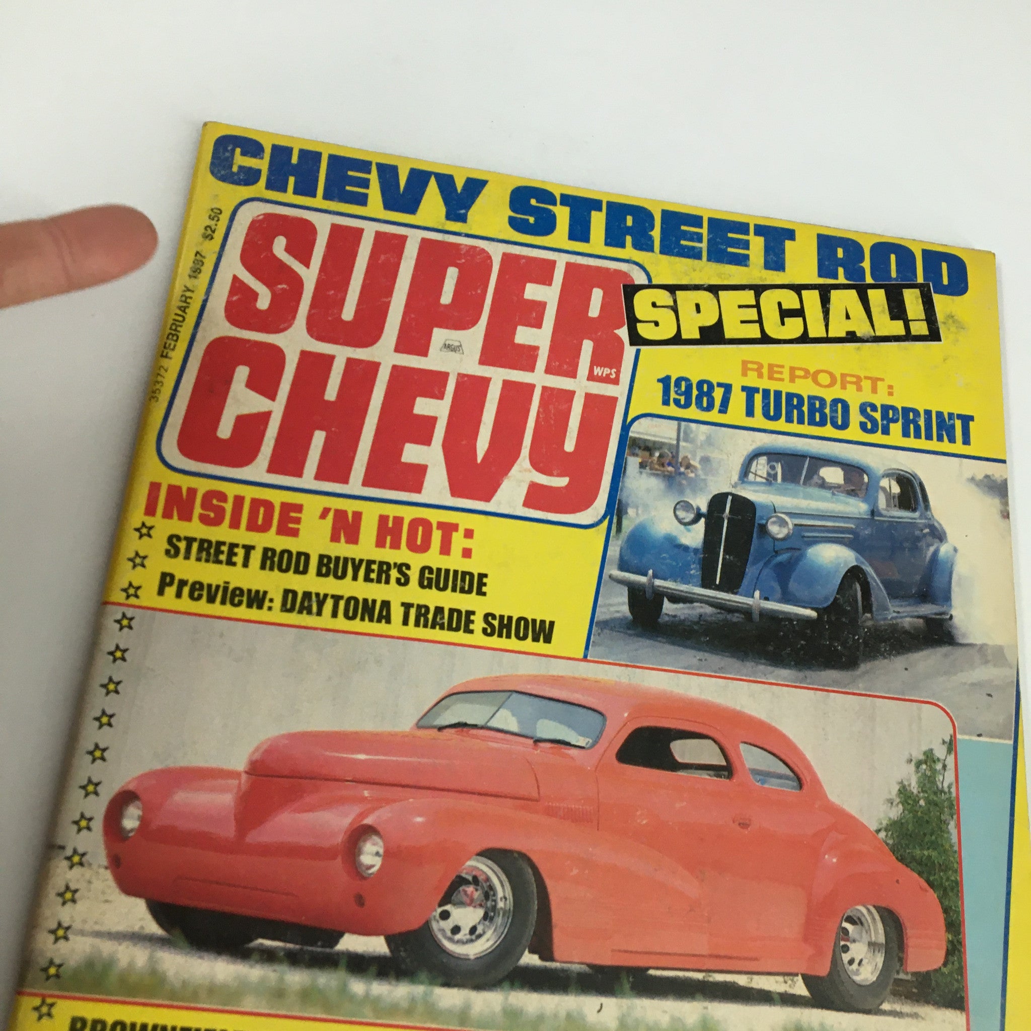 Cover detail of VTG Super Chevy Magazine February 1987 showcasing Larry Rhodes 35 East Coast Coupe, emphasizing street rod features, Daytona Trade Show previews, and more.