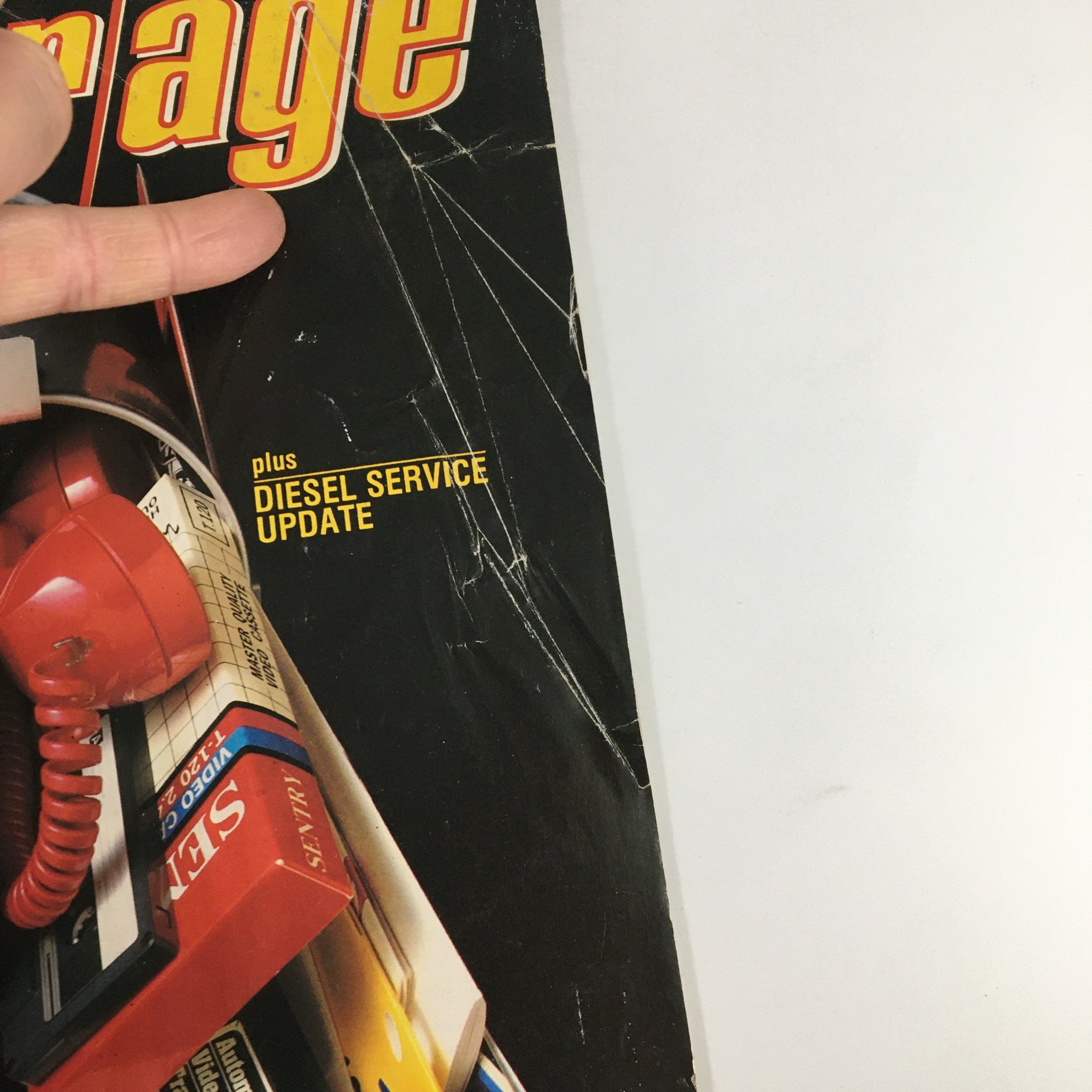 Close-up of the cover of VTG Chilton's Motor Age Magazine June 1986, featuring a red phone and tools with a note stating 'plus DIESEL SERVICE UPDATE'.